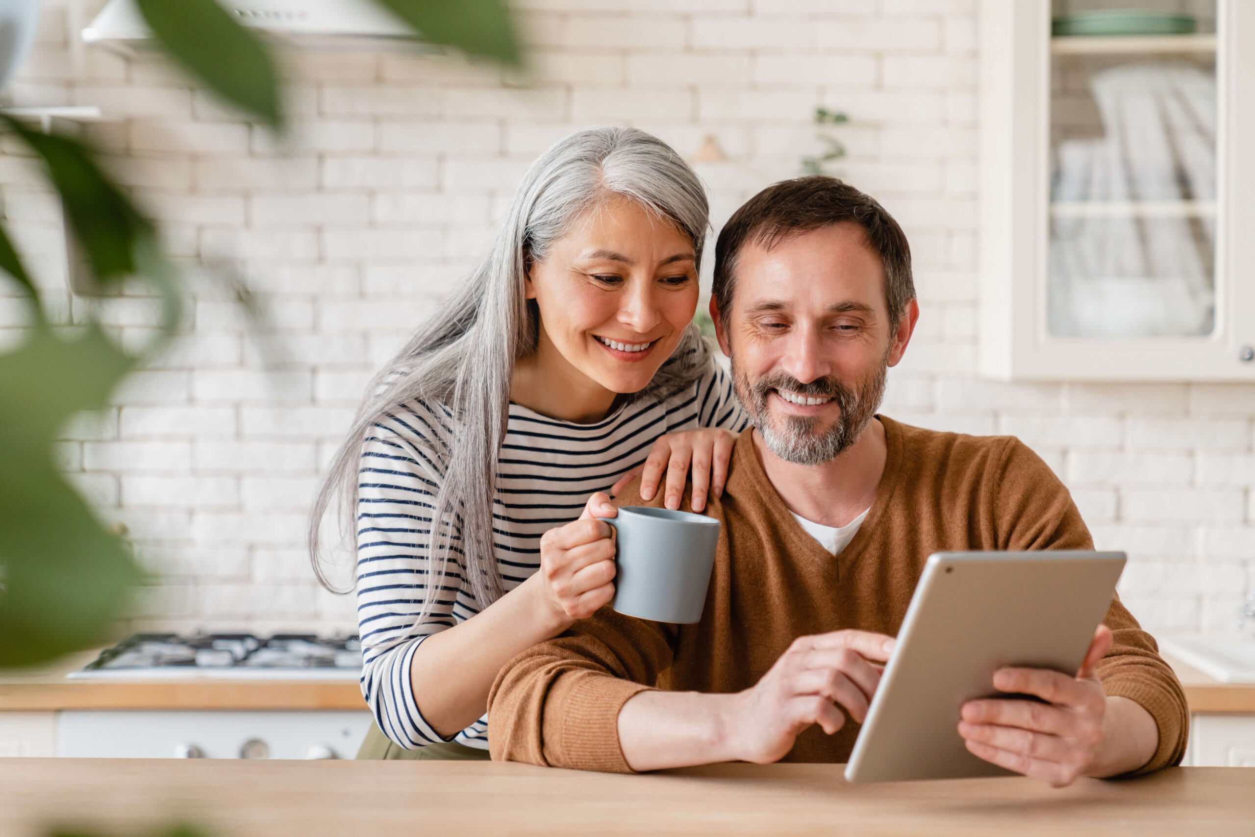 50+ couple checking laptop