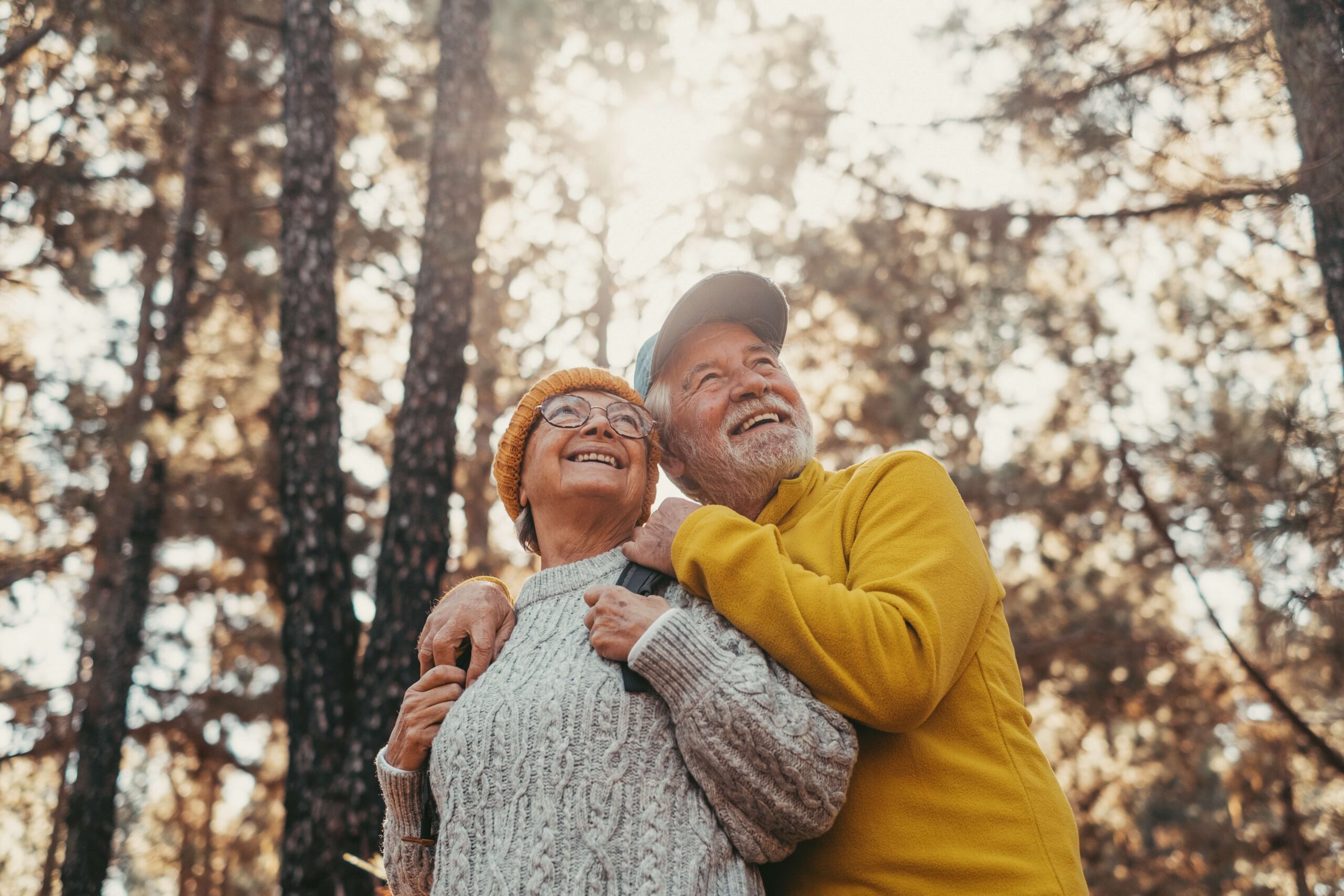 mature couple looking up in woods