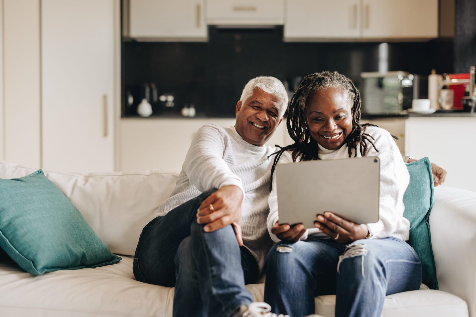 Couple on a sofa looking at a tablet