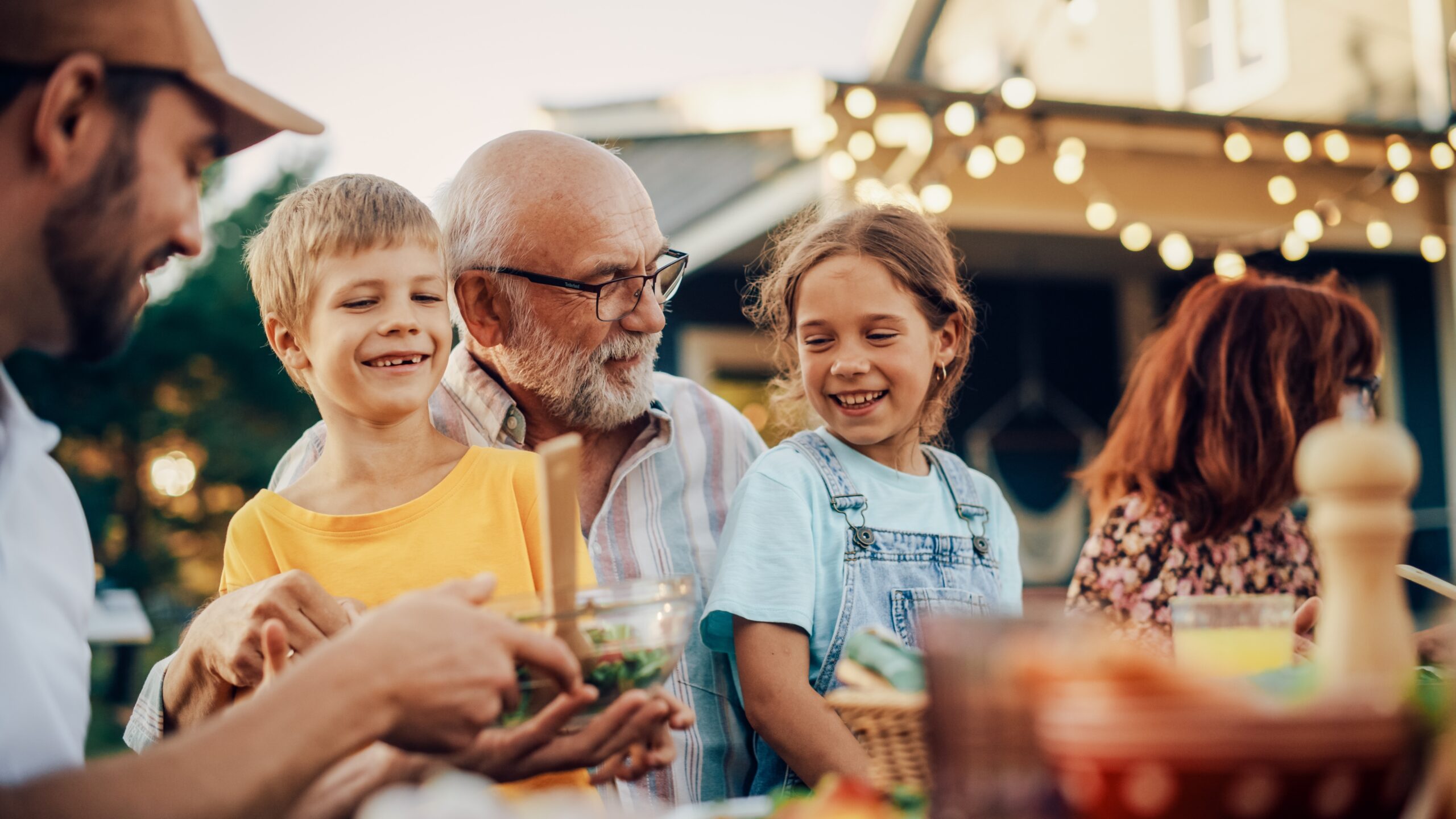 Mature man smiling with grandkids