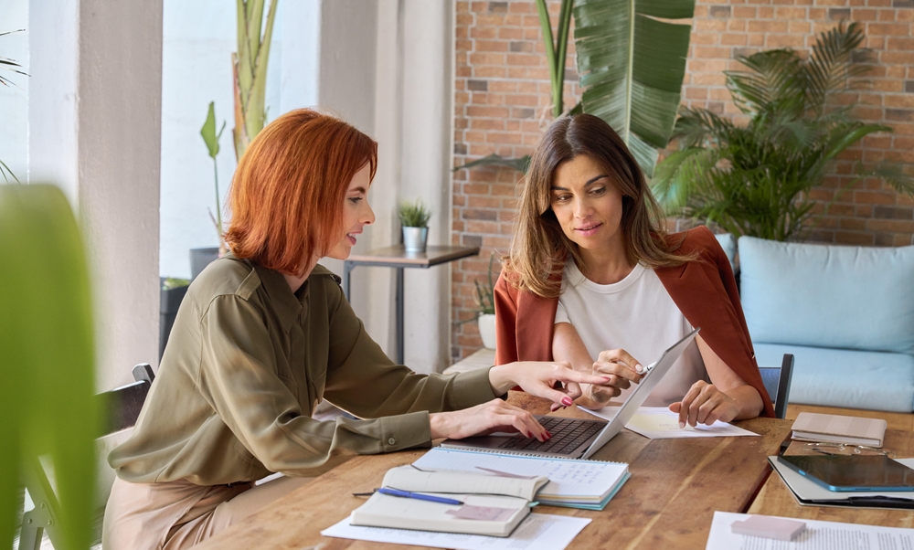 Two women looking at computer