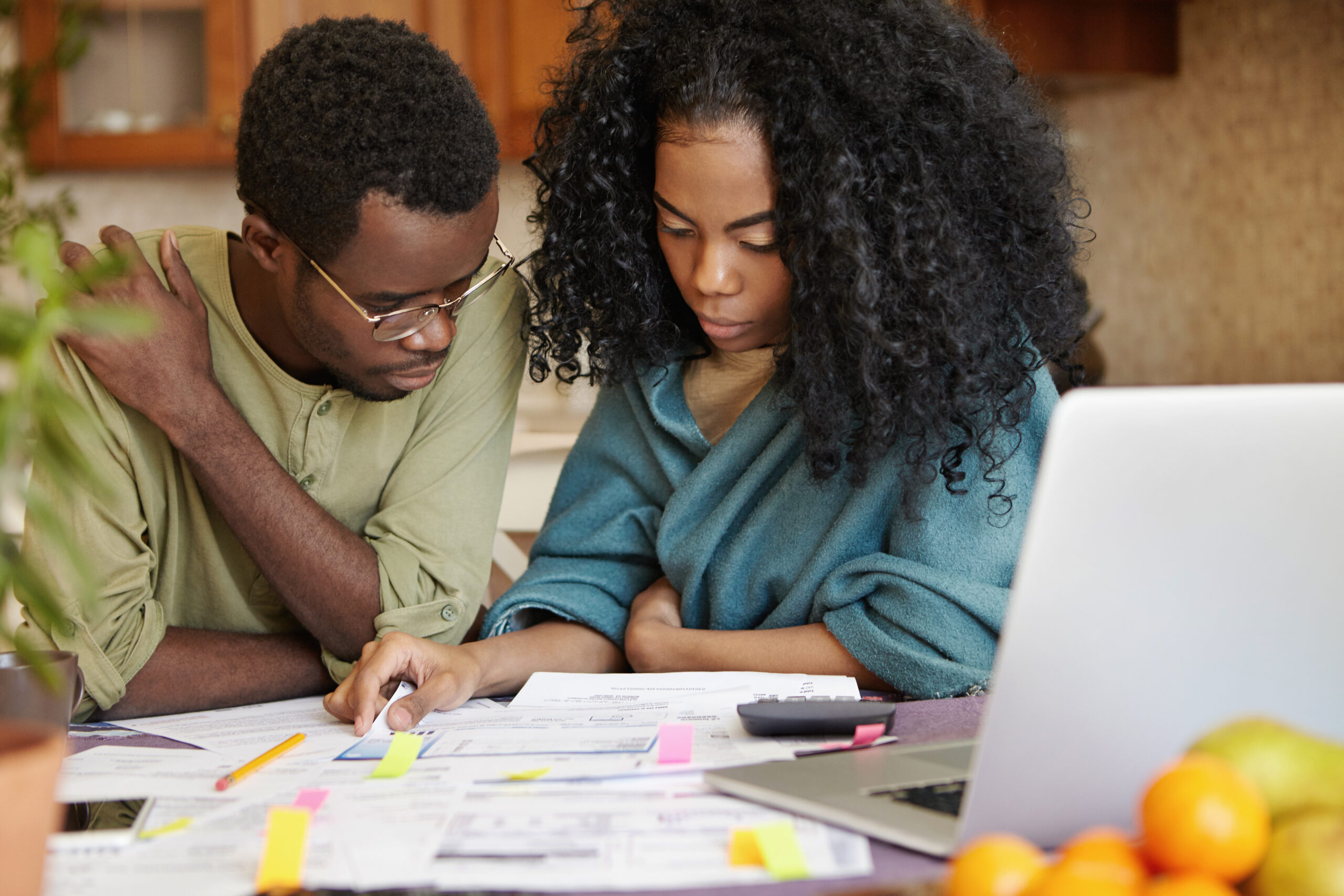 Couple looking at lots of bills and paperwork