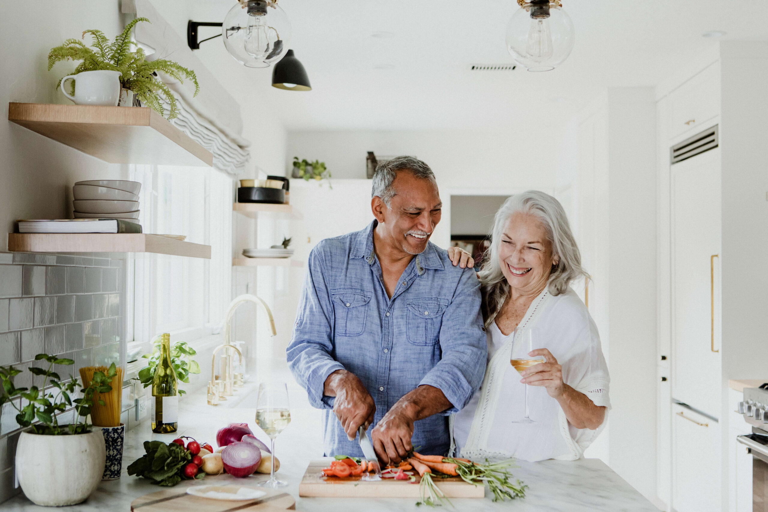 Bi racial mature couple cooking