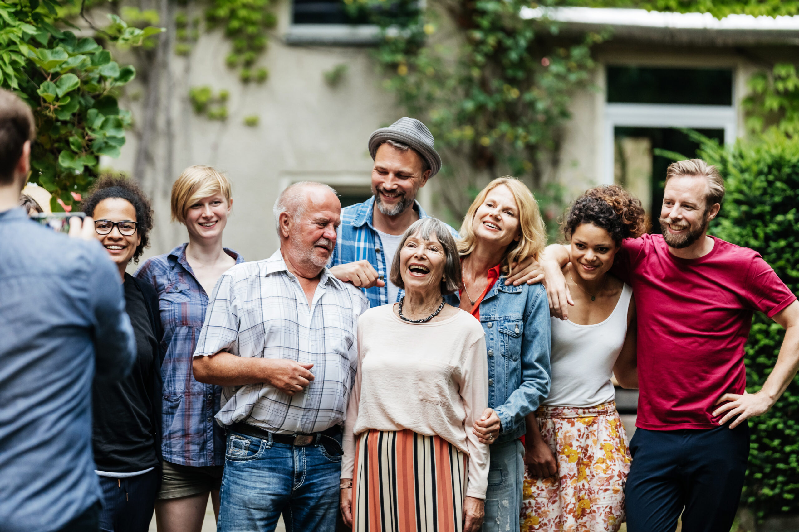 Man Taking Group Photo Of Family At BBQ