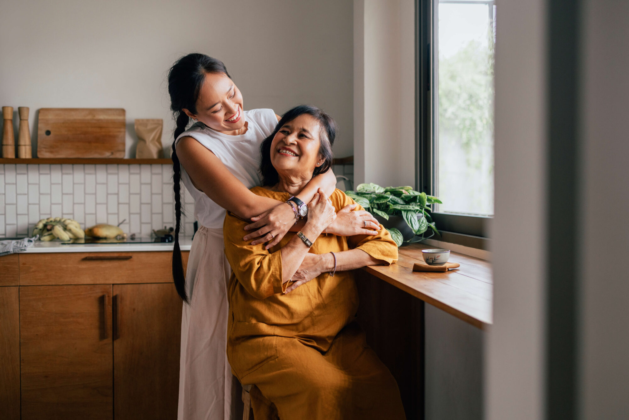 Mother and daughter hug and smile