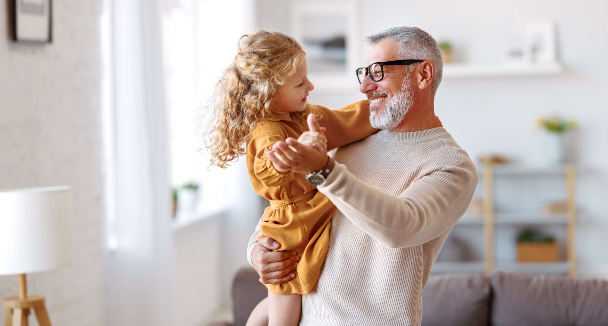 Grandfather dancing with young granddaughter