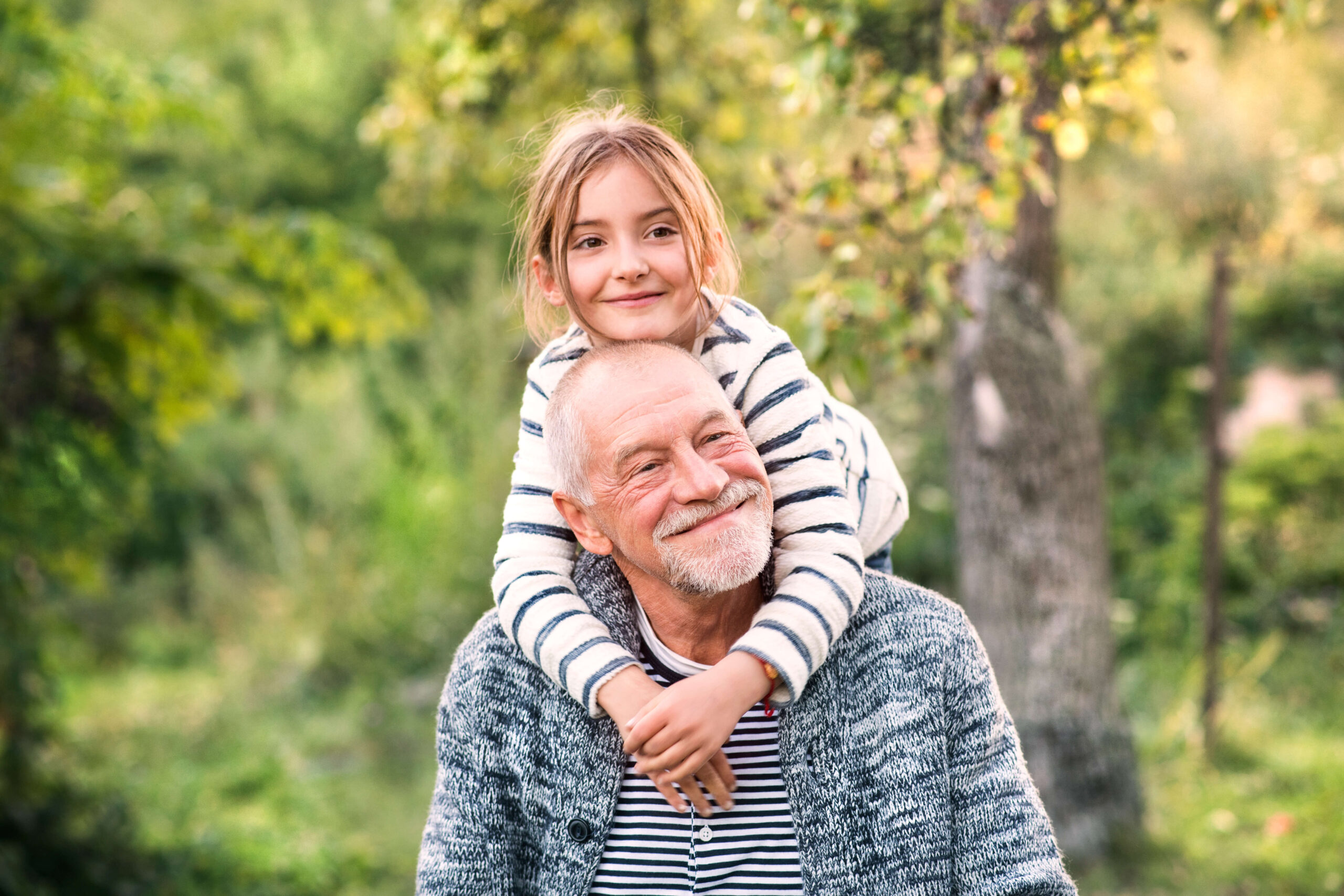 Grandfather with granddaughter on shoulders