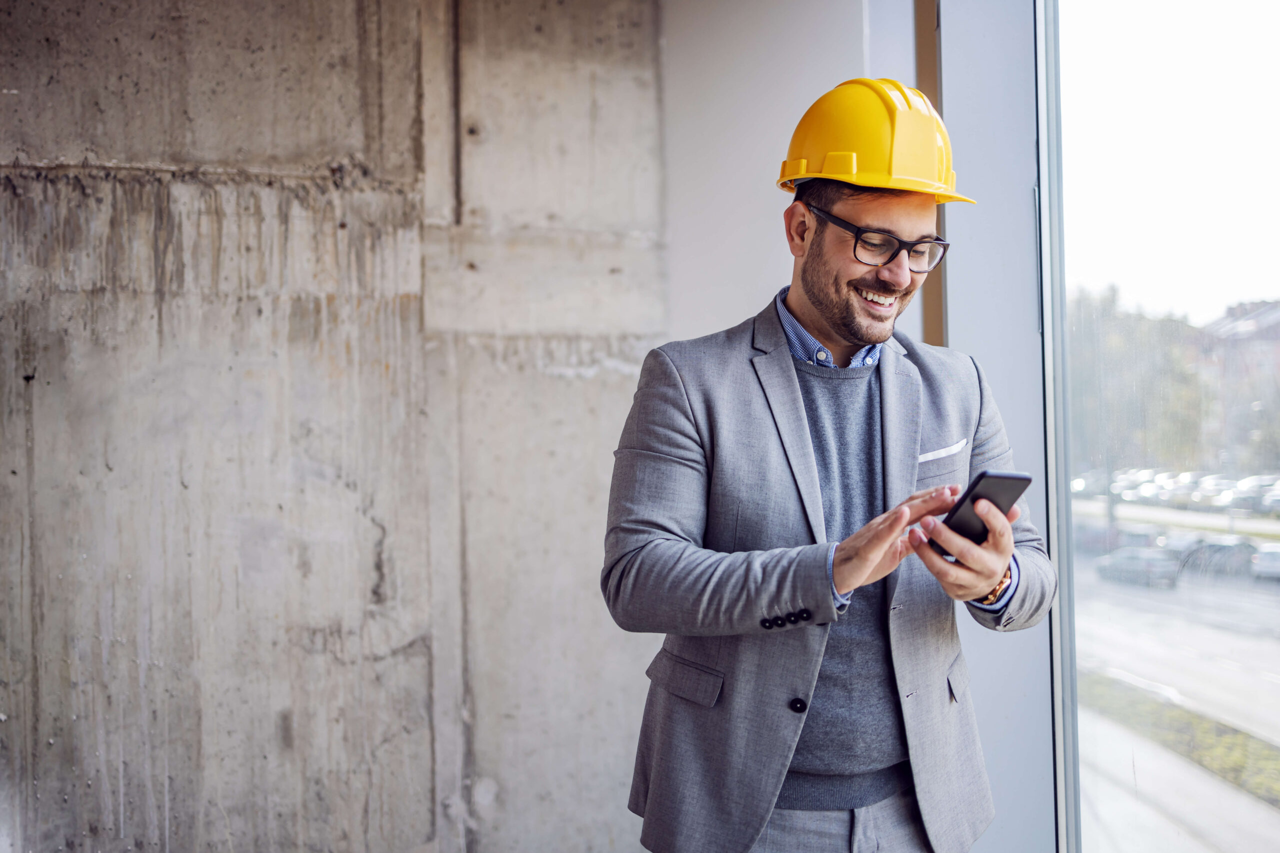 Man on phone smiling on site