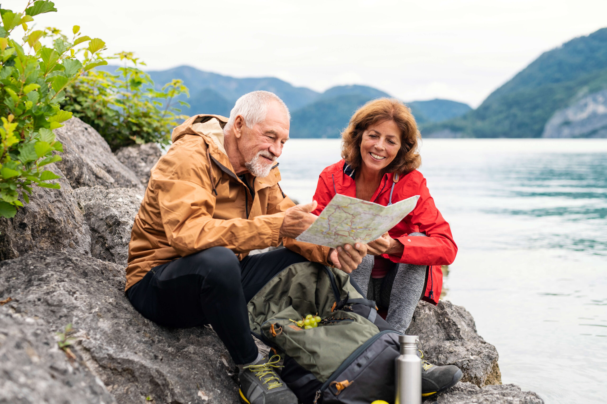 Mature couple hiking looking at map