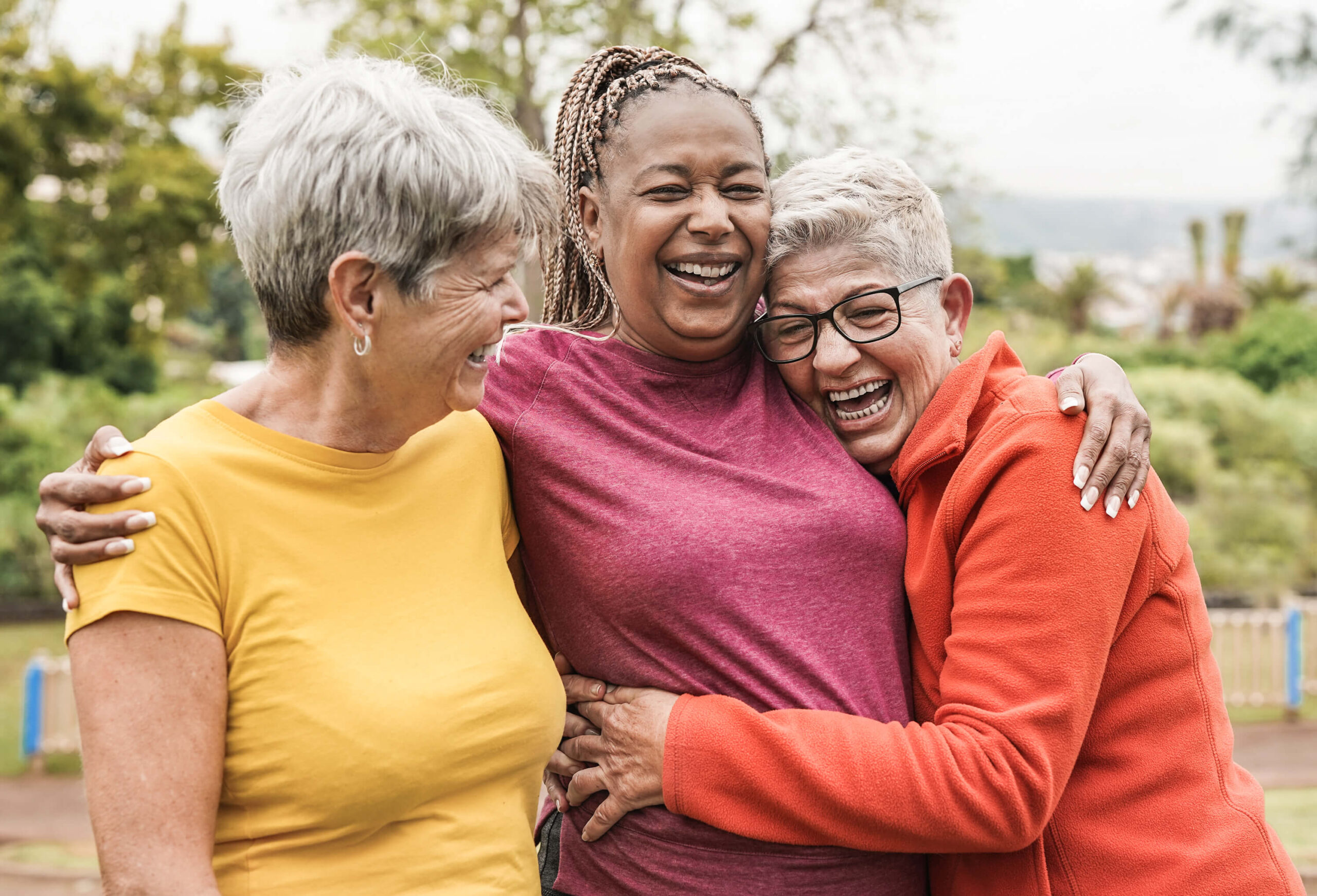 Mature female friends hugging