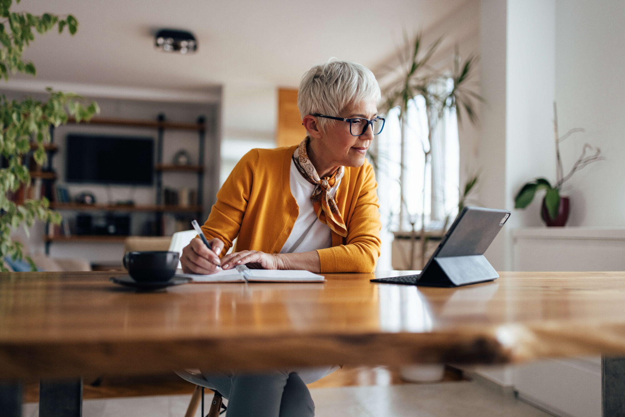 Mature lady in kitchen on laptop