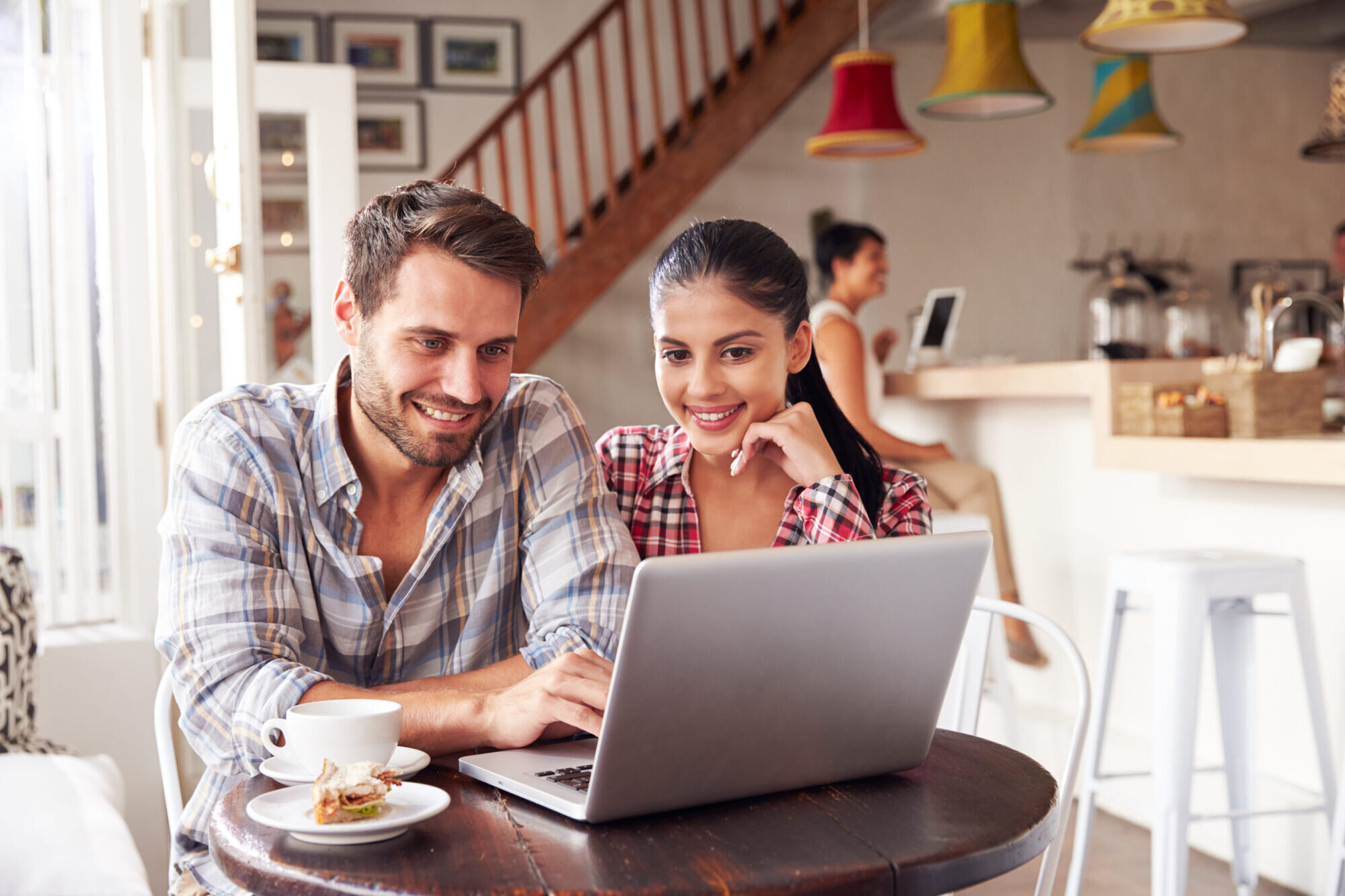 Couple looking at laptop smiling