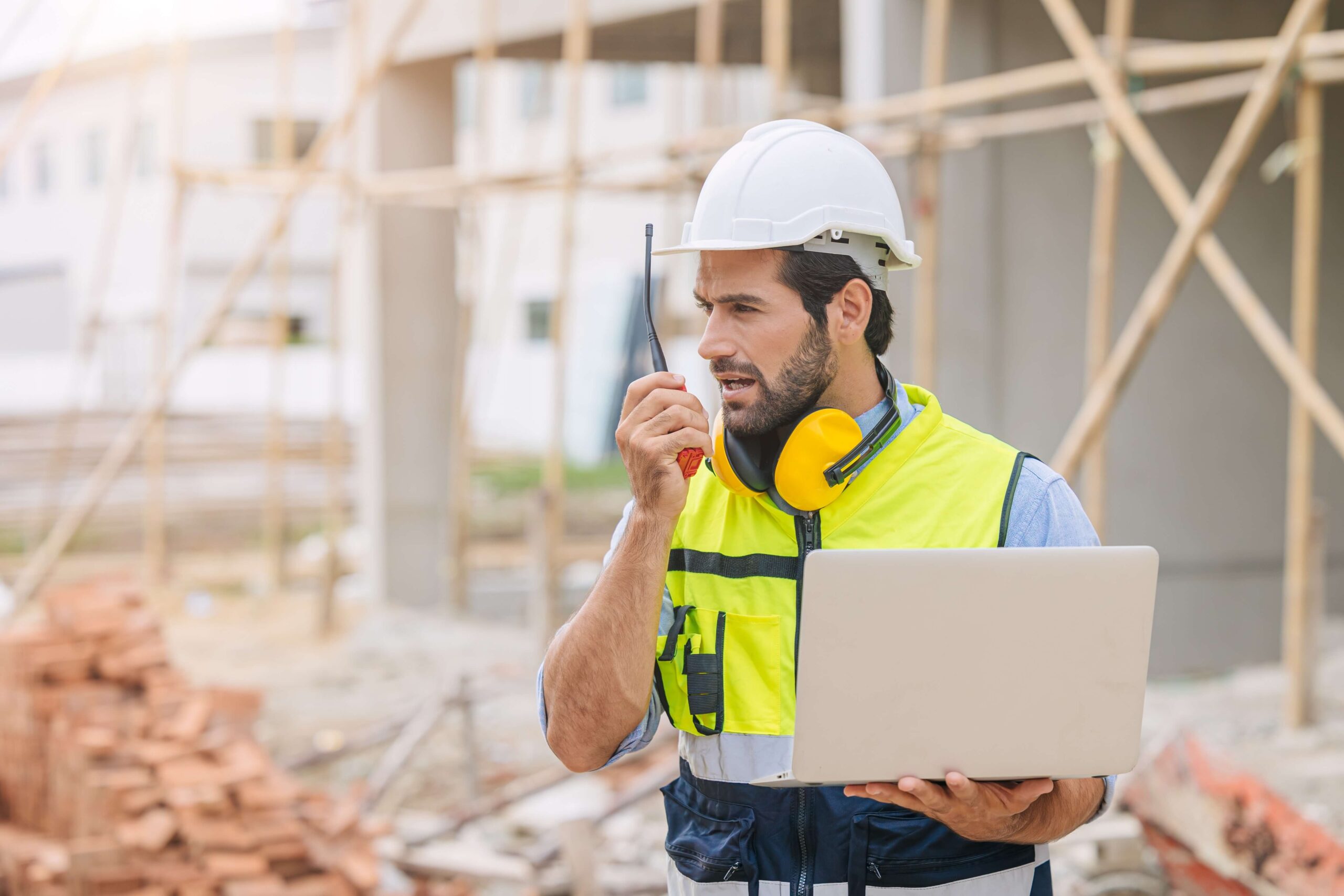 Site - man on 2 way radio with laptop