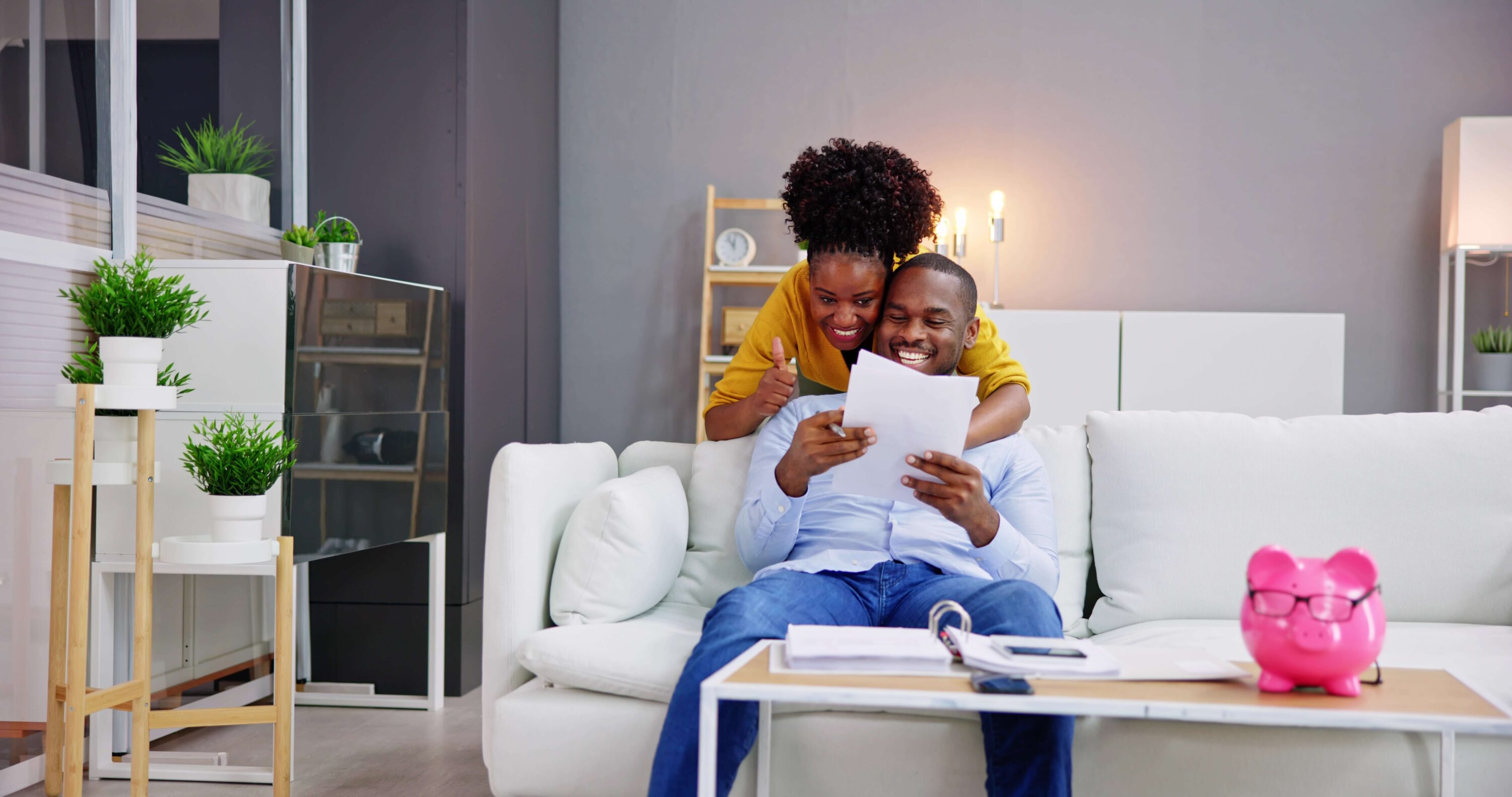 black couple saving piggy bank