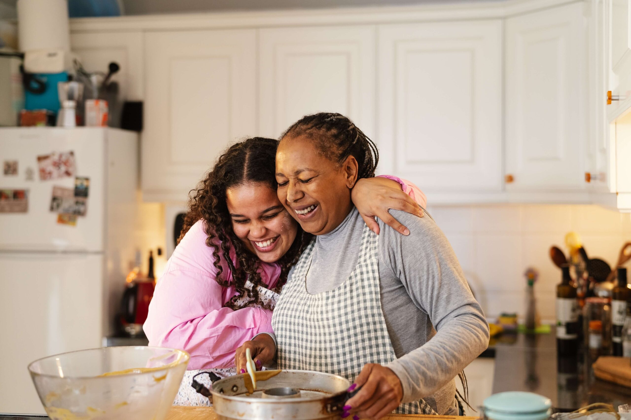 black mum and daughter baking