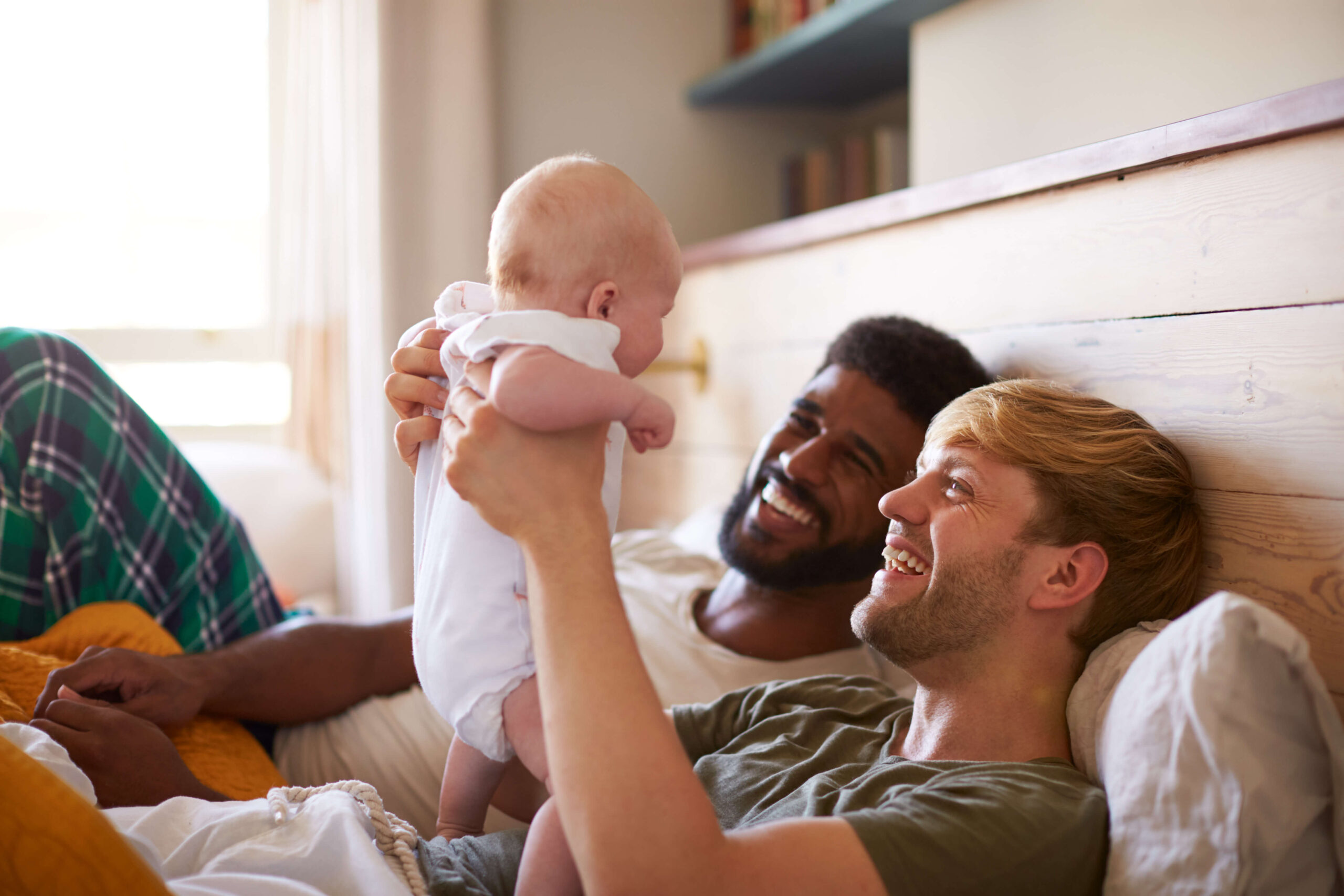 gay couple baby smiling