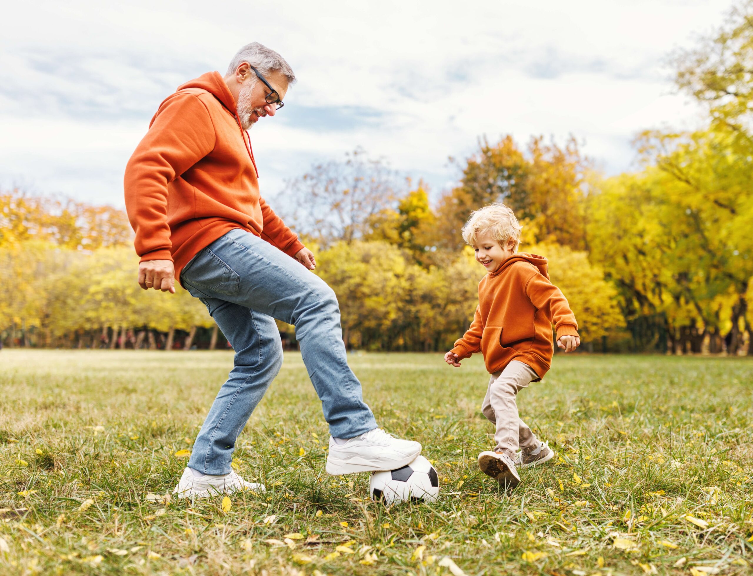 grandad and grandson playing football