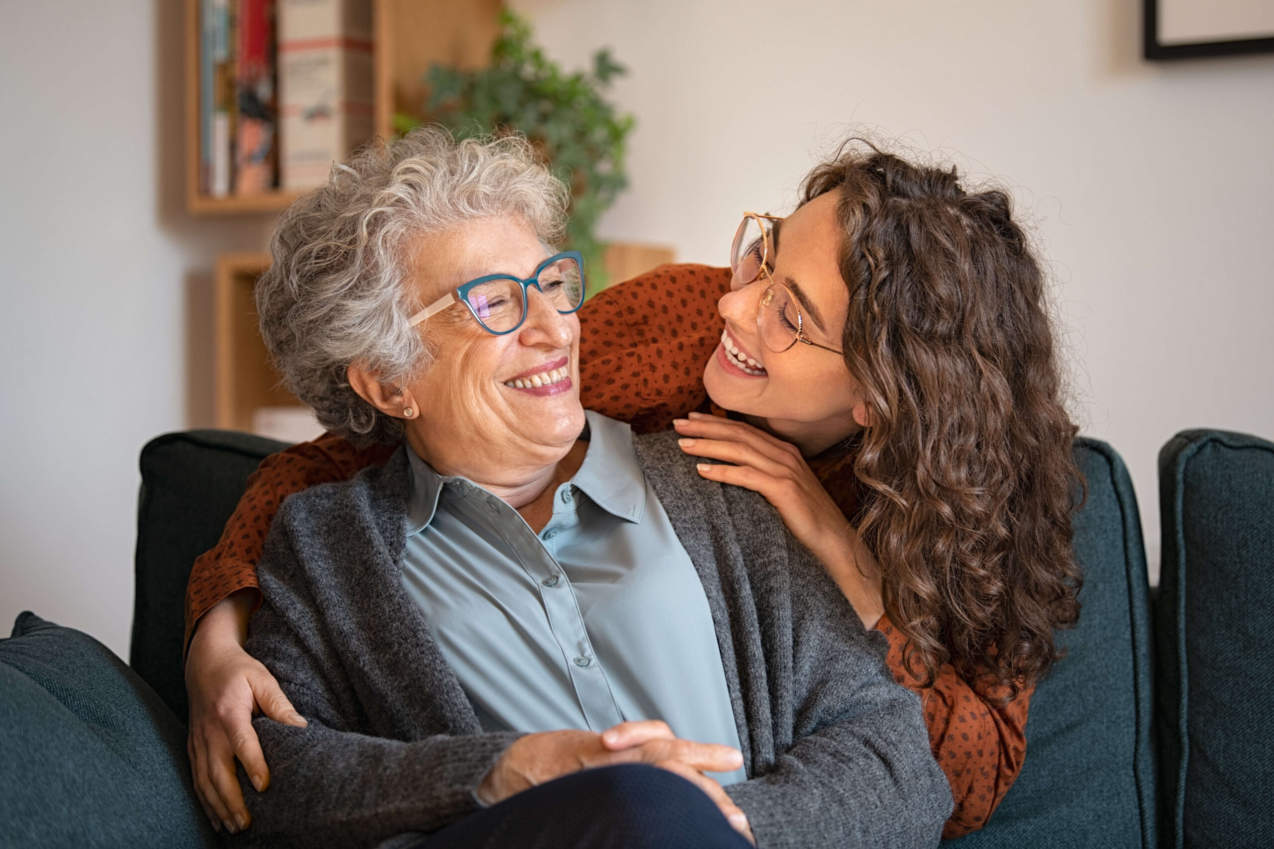 grandmother and granddaughter sofa hugging