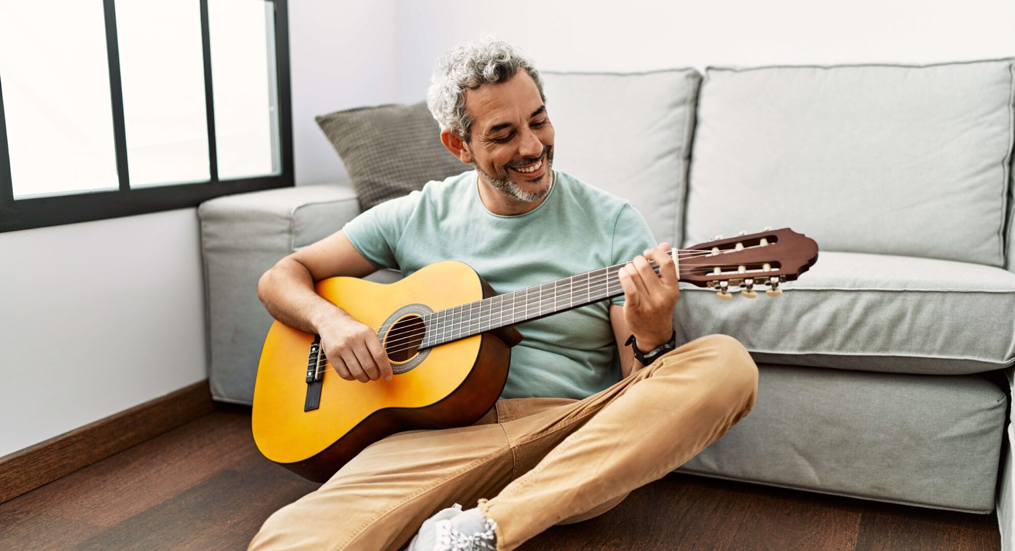 Man on guitar smiling