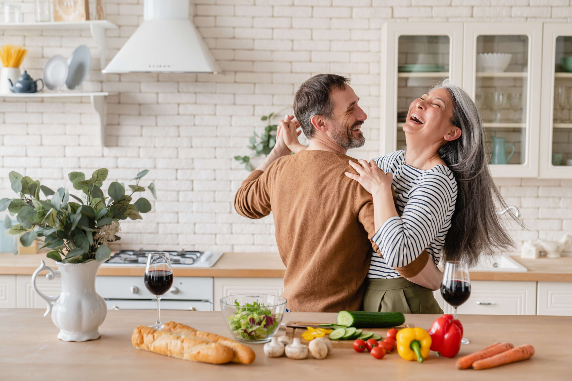 mature couple dancing in kitchen