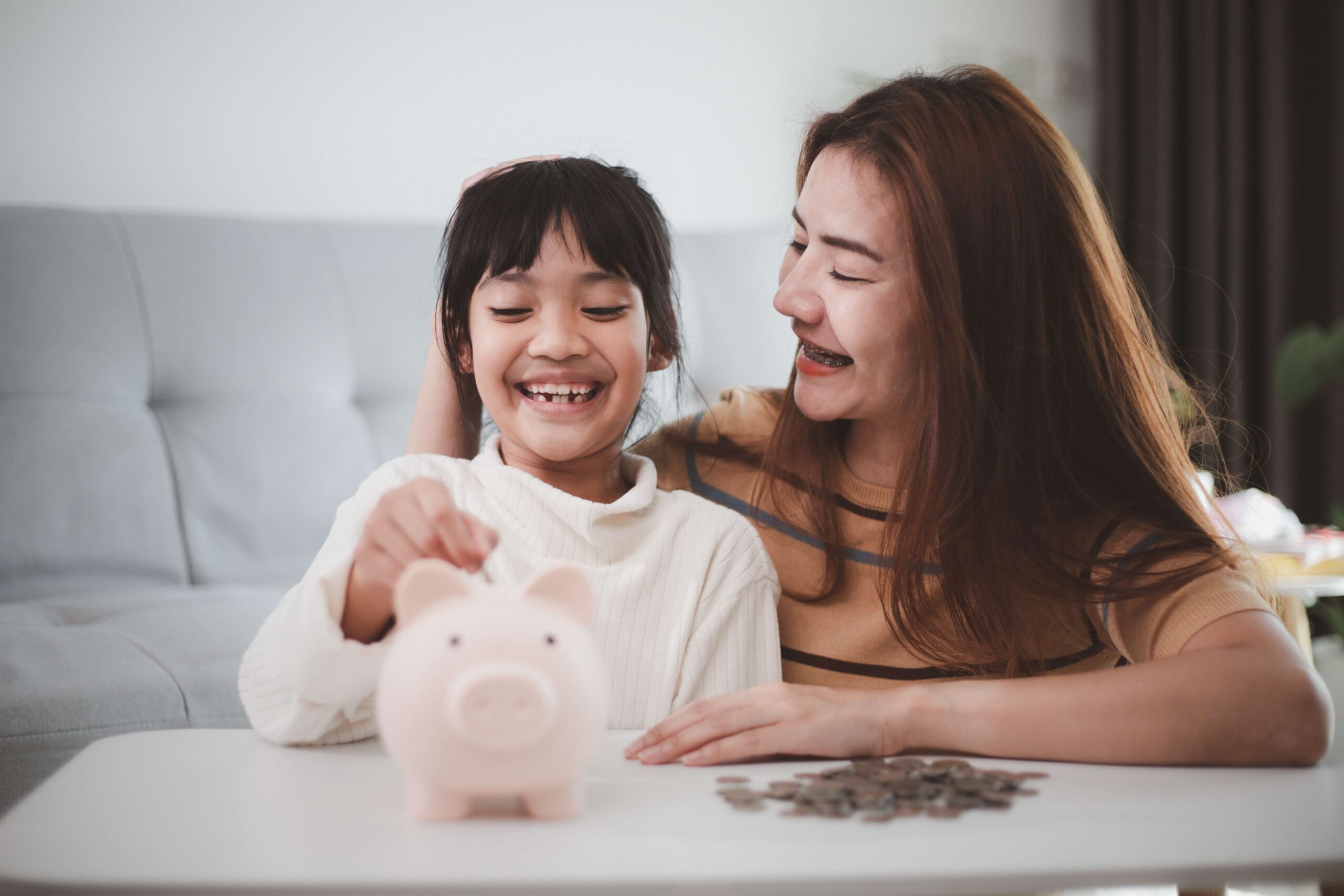 Mother and daughter with piggy bank