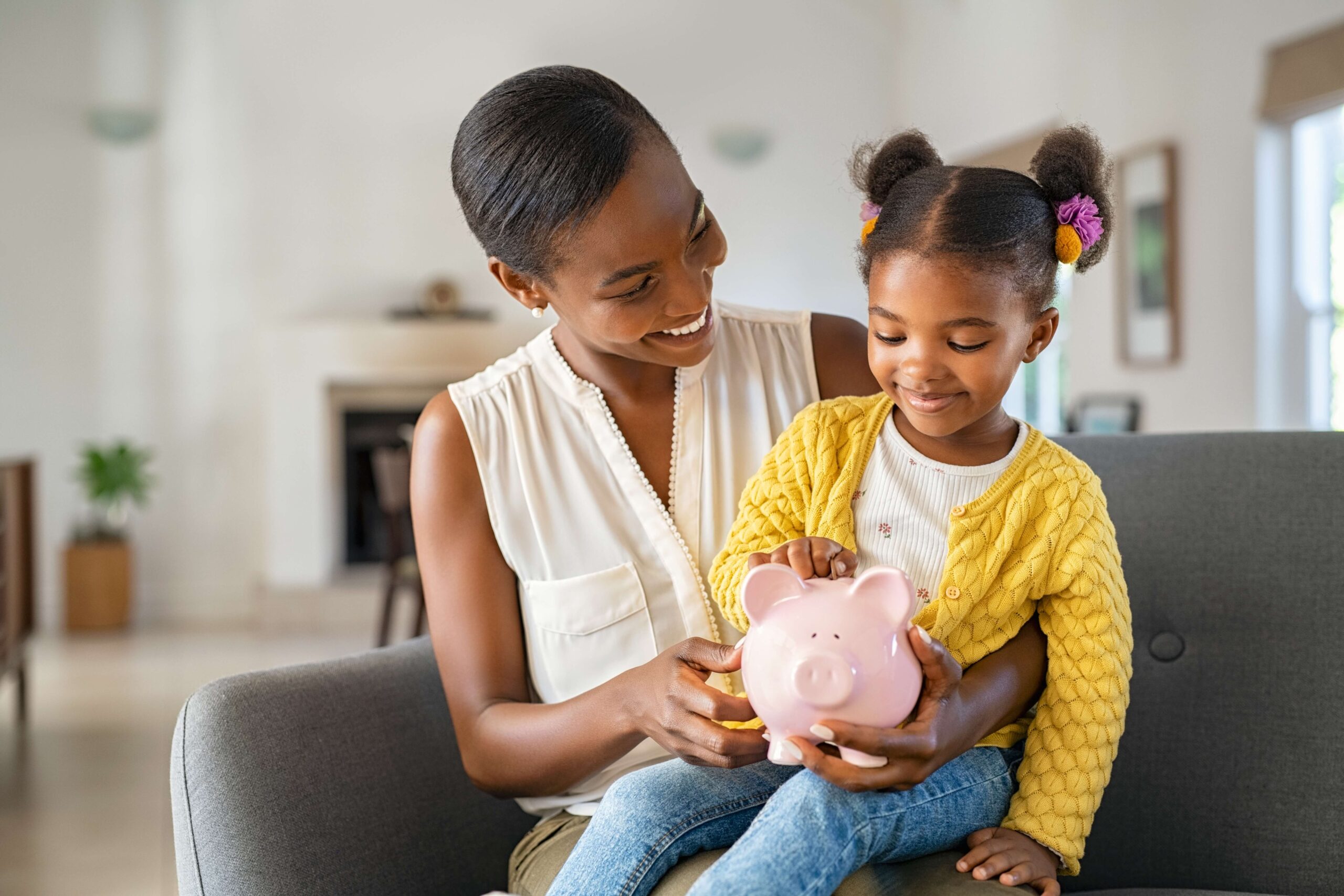 Mother and daughter with piggy bank