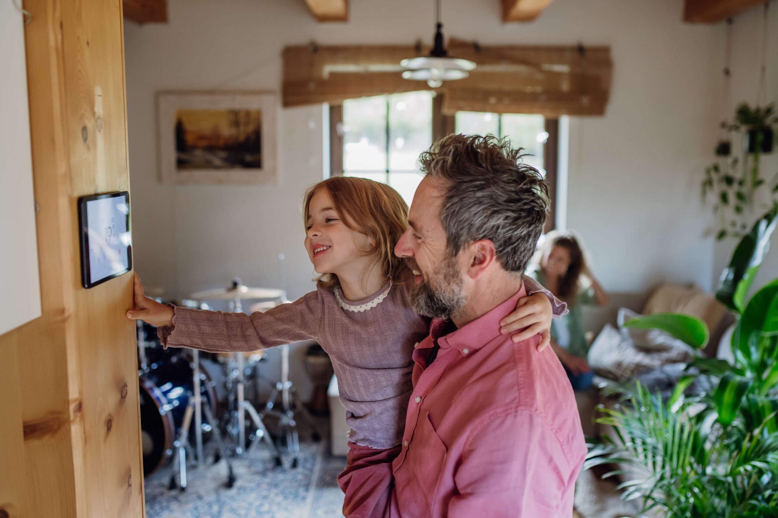 Man and young daughter look at smart meter