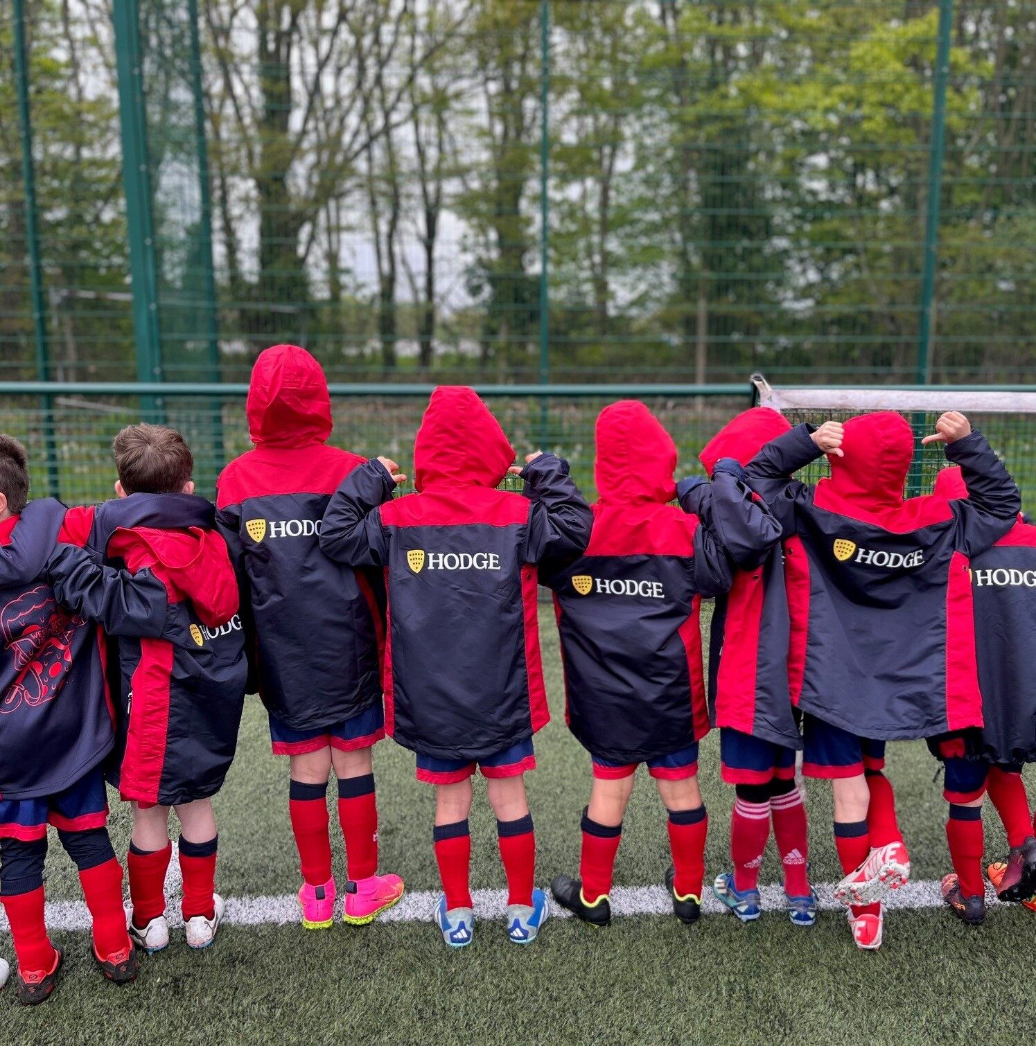 A group of children wearing Hodge branded jackets