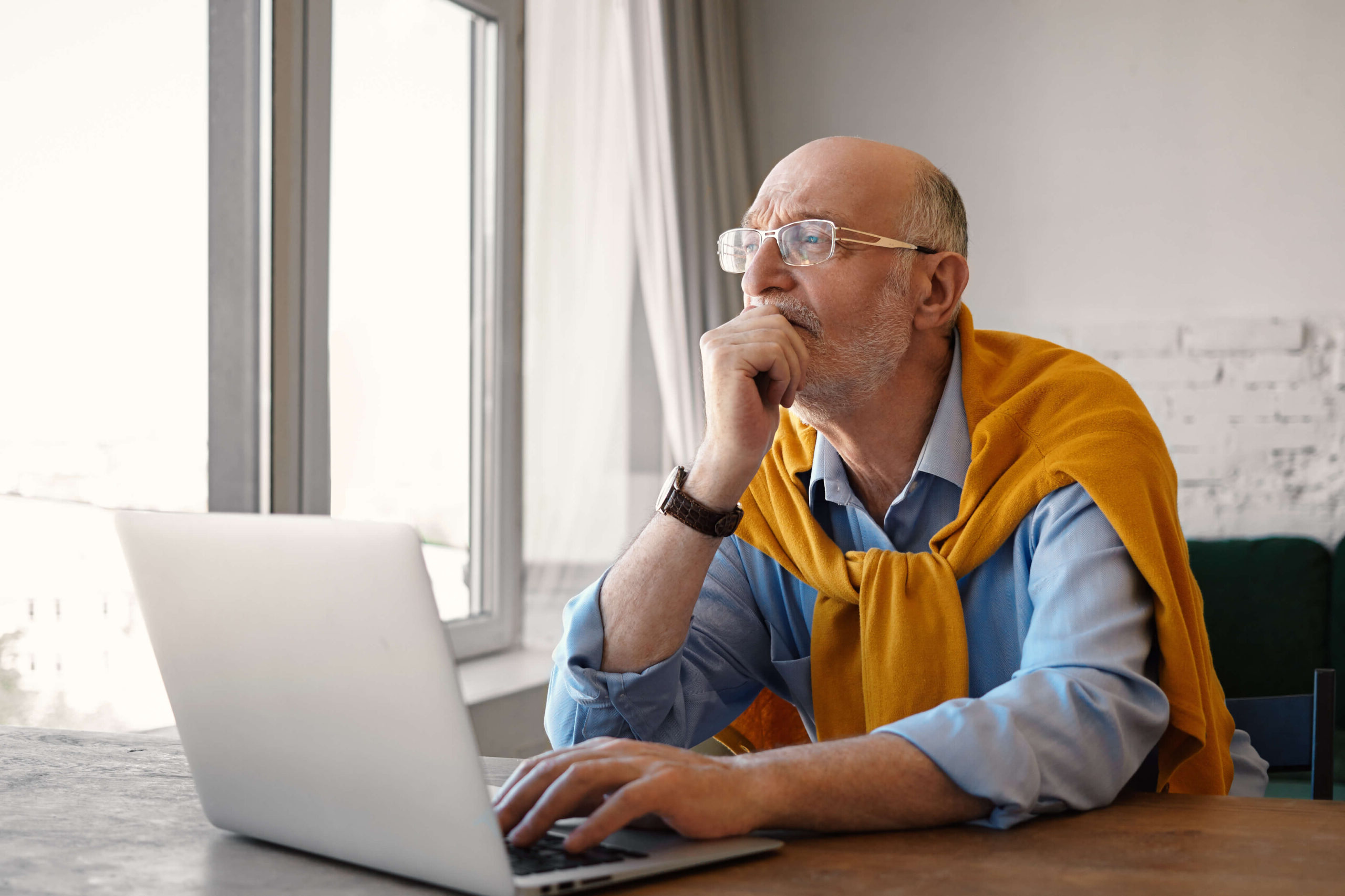 Man looking concerned at laptop