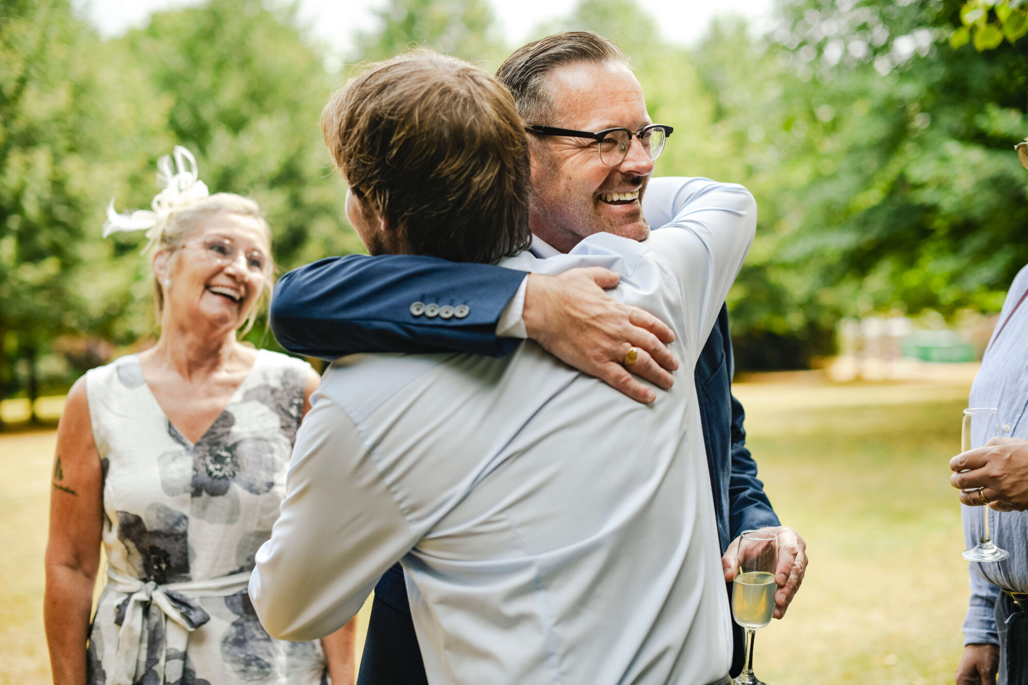 Dad hugging son at wedding