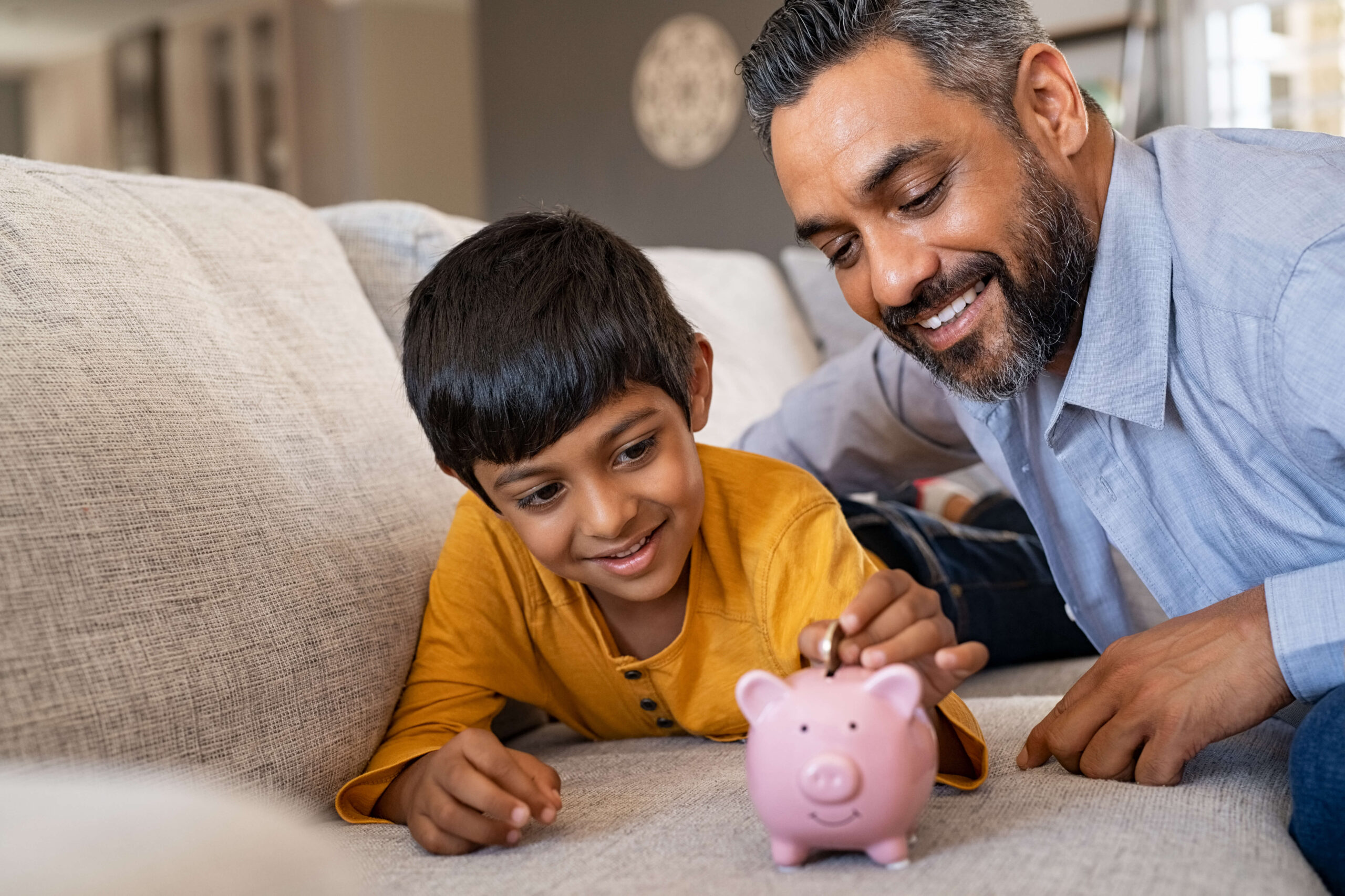 Dad , son and piggy bank