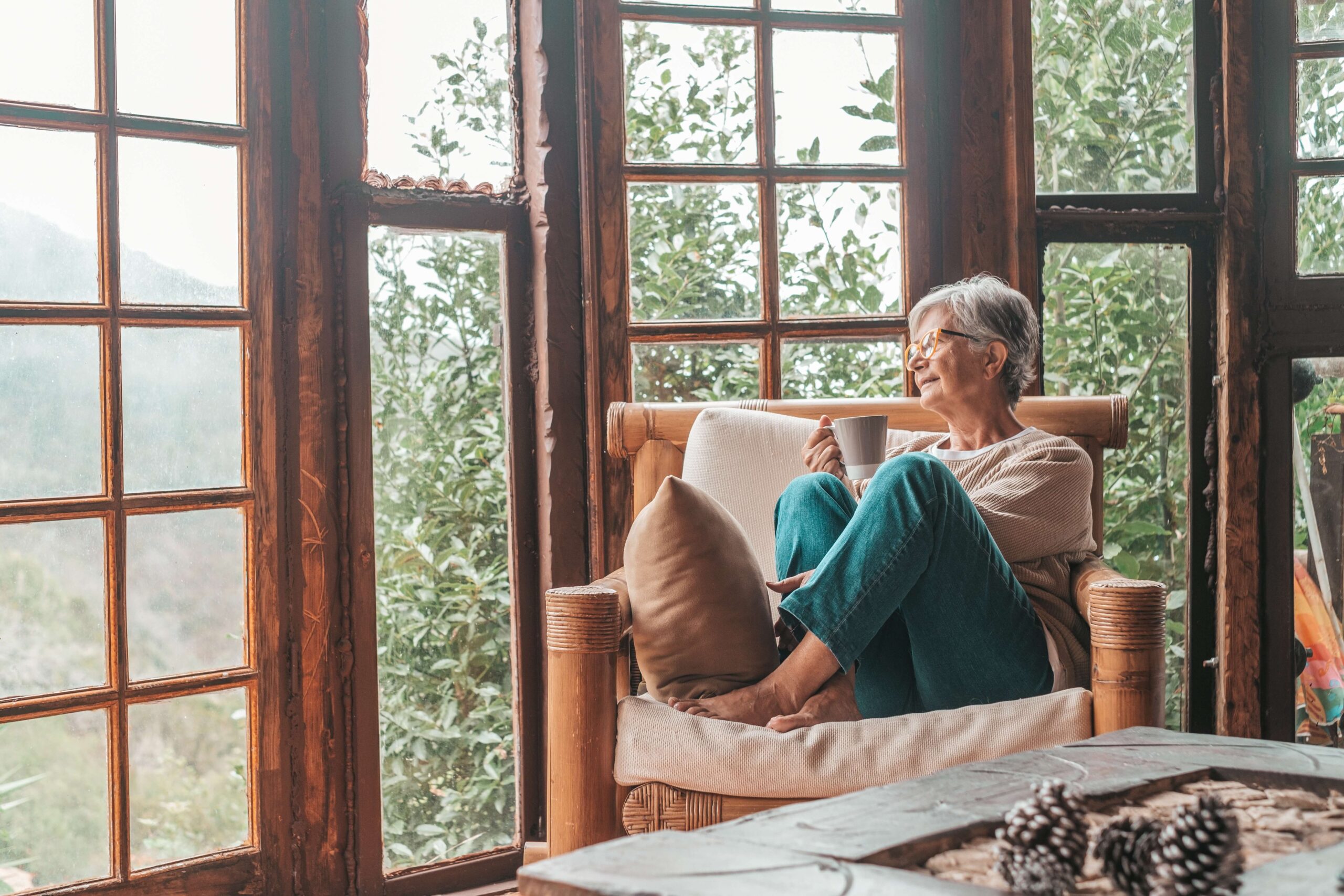 Mature woman looking thoughtfully out of window