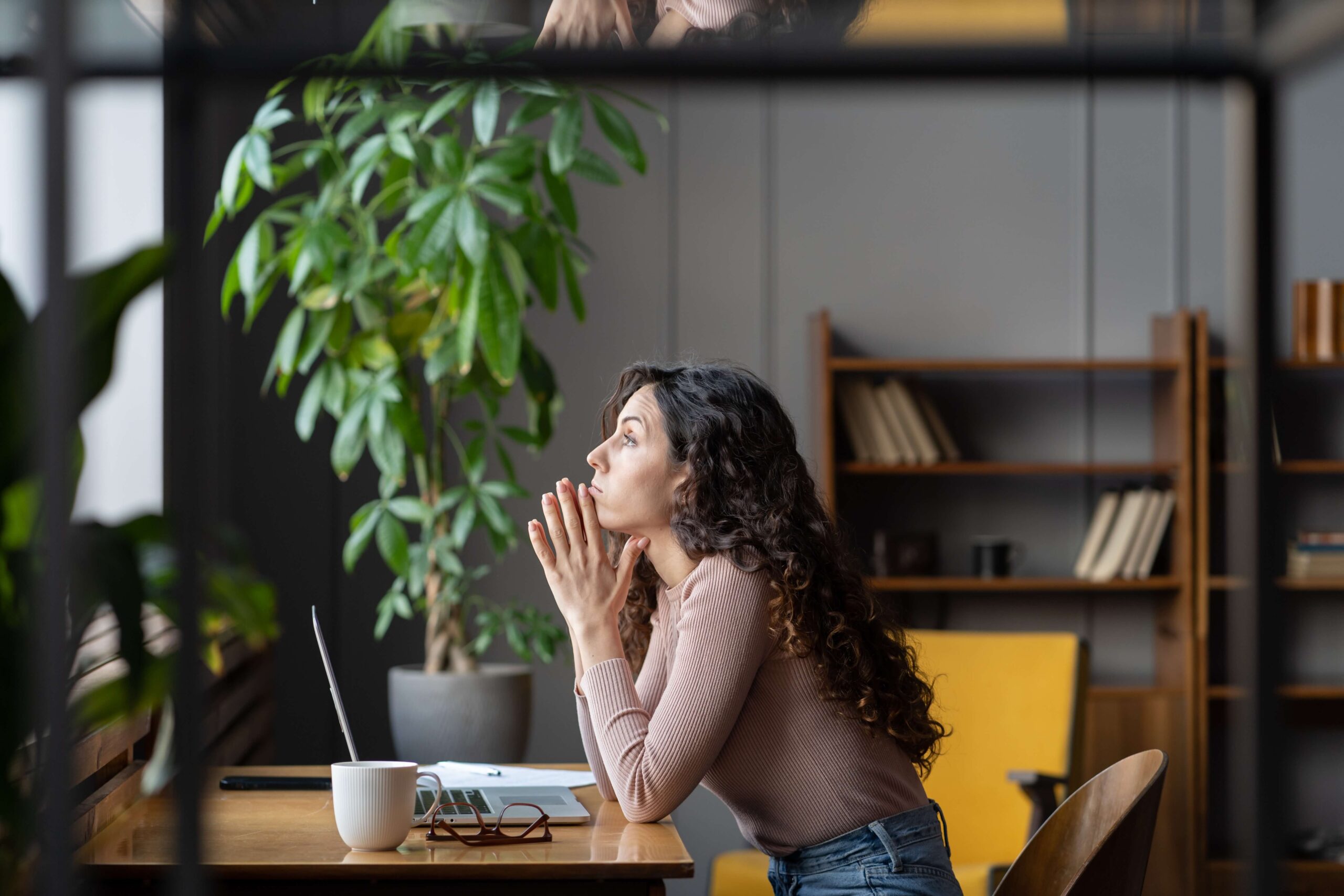 Young woman looking concerned at desk