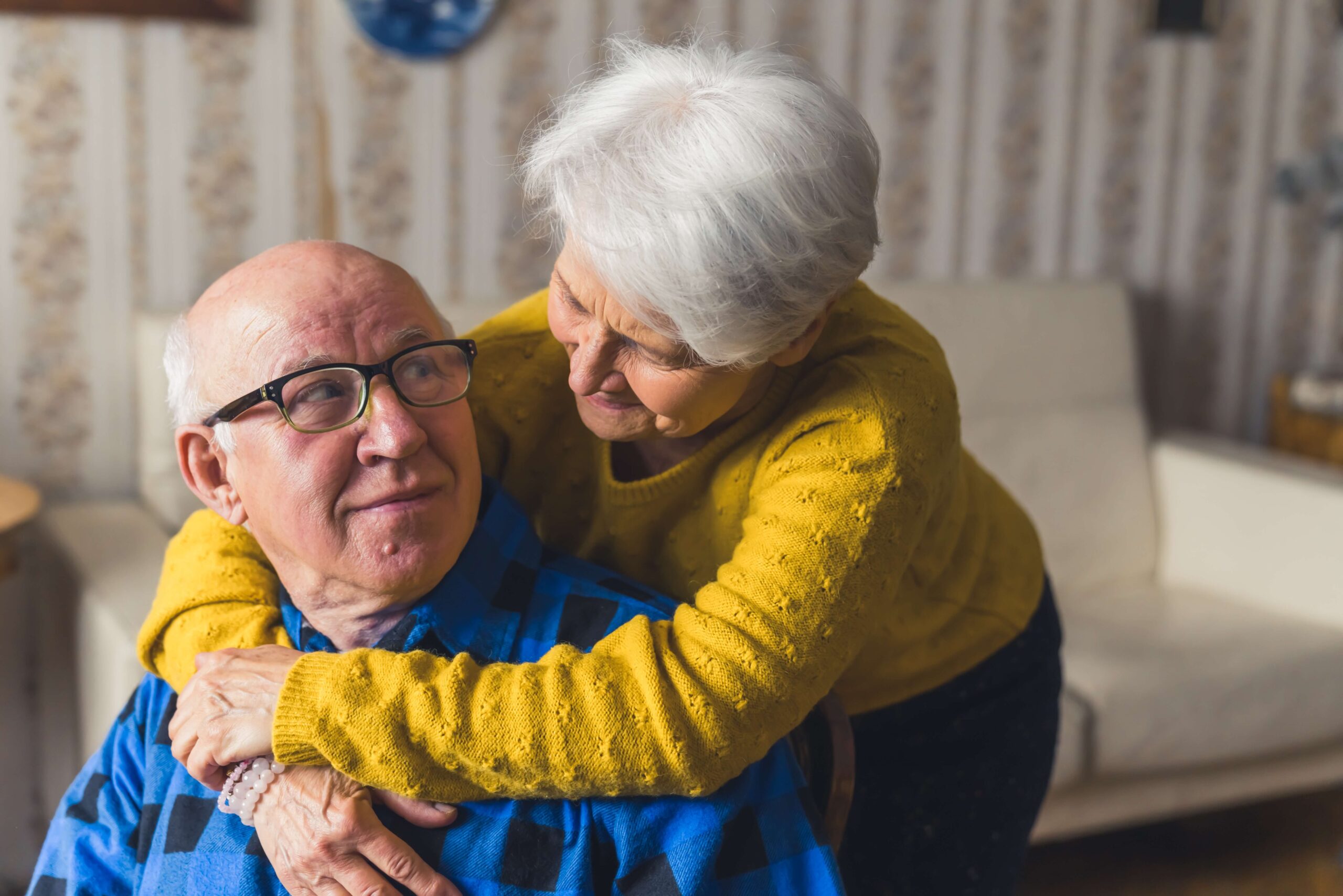 Mature couple over shoulder hugging