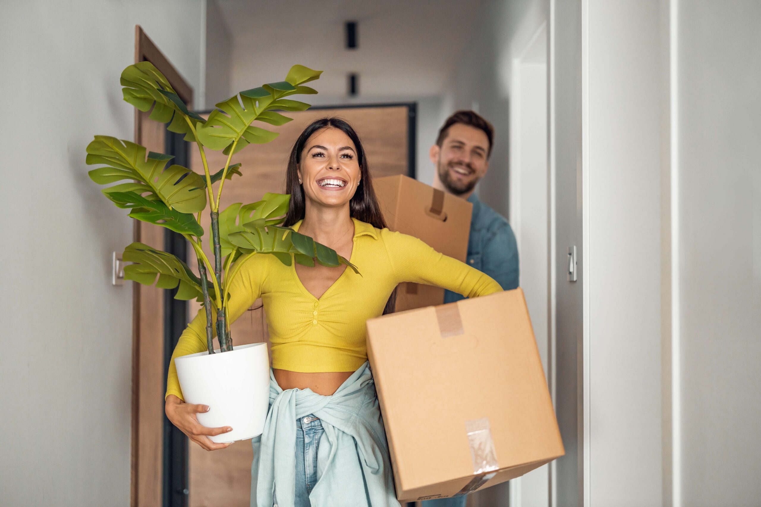 Young couple moving into new home happy