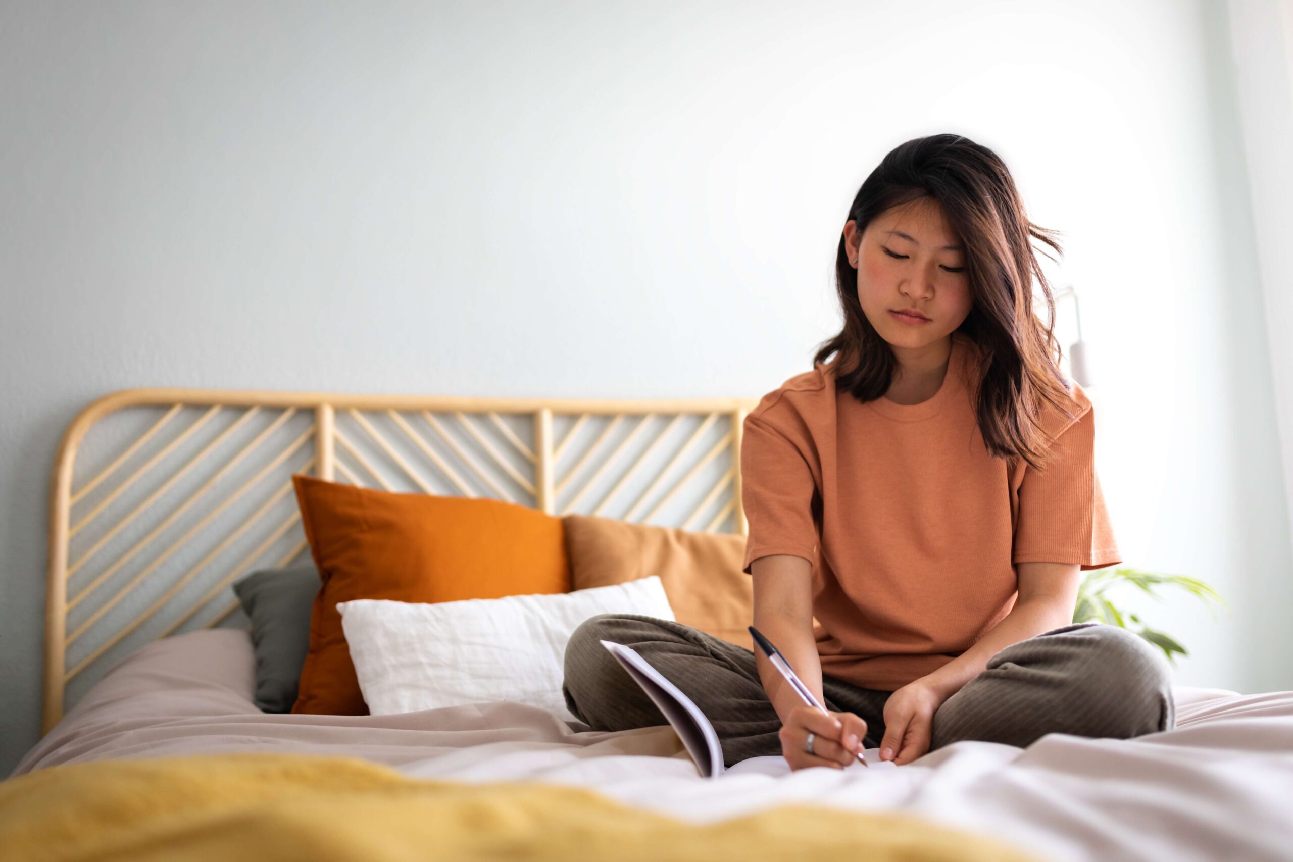 Student on bed working