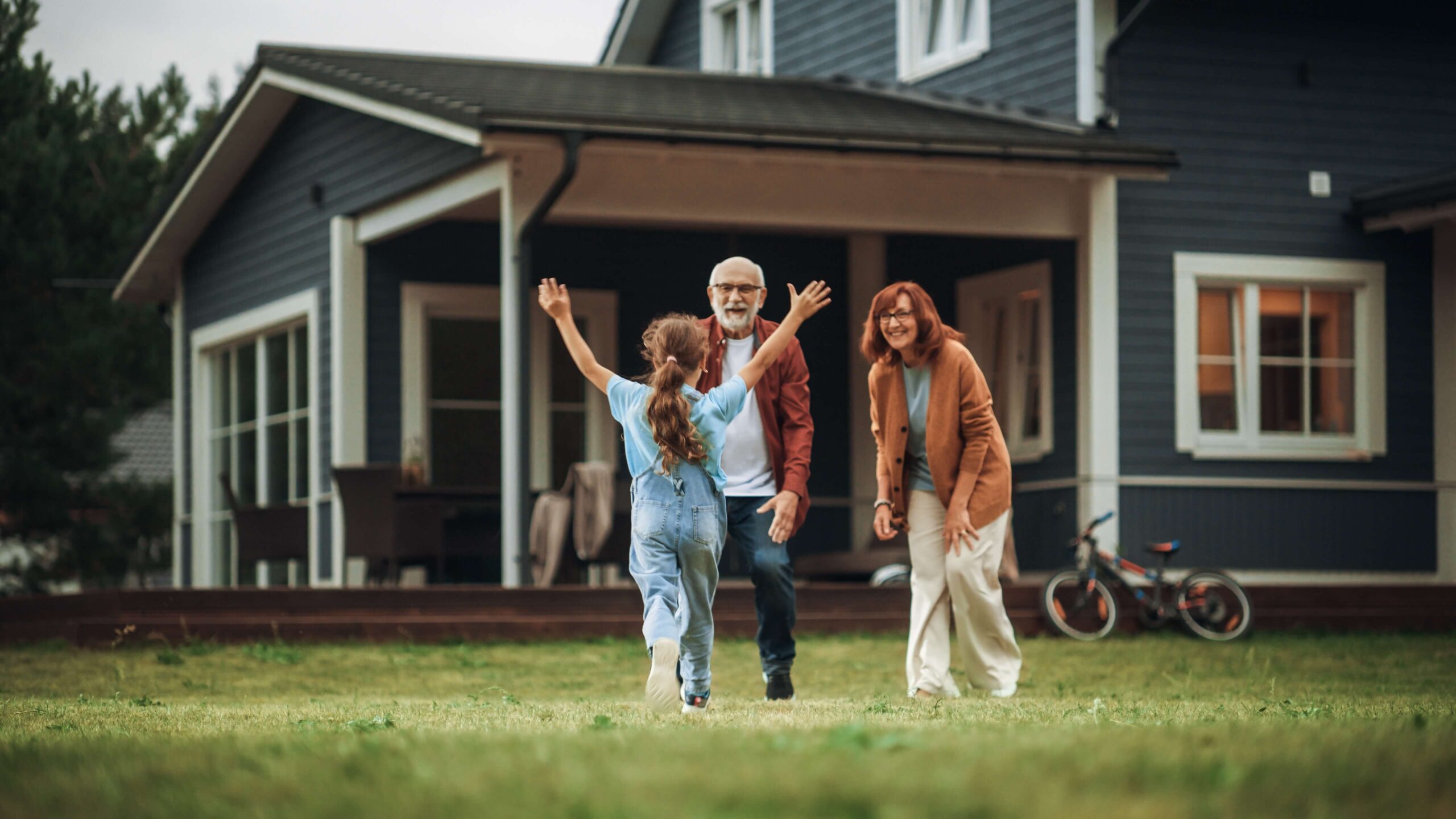 Grandparents outside with granddaughter