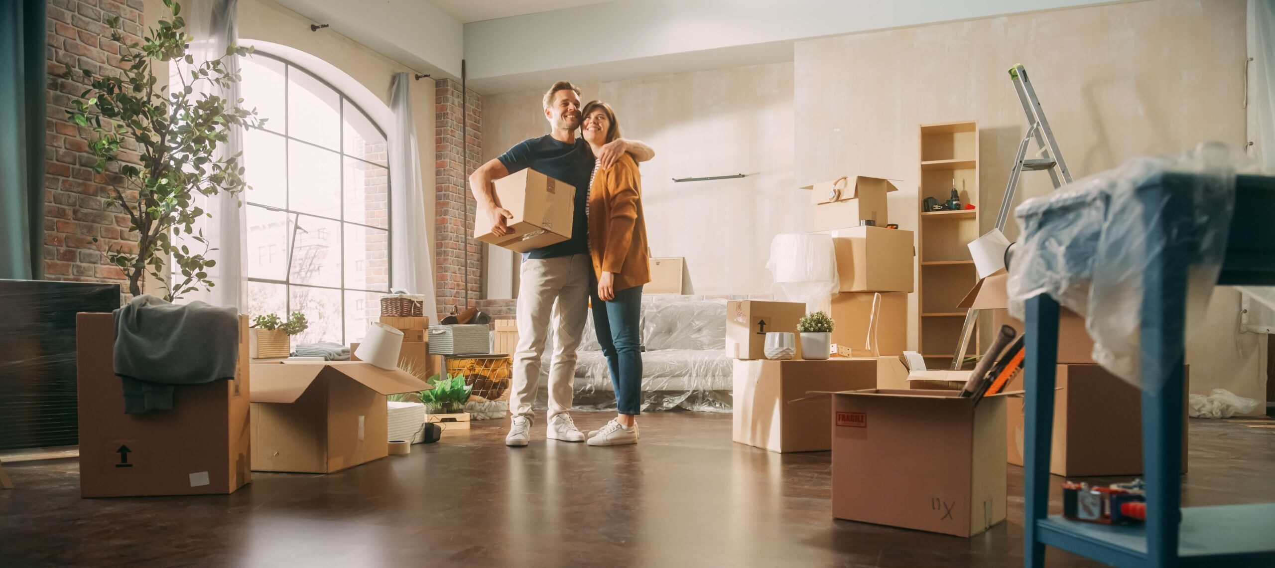 Couple moving into first home with boxes