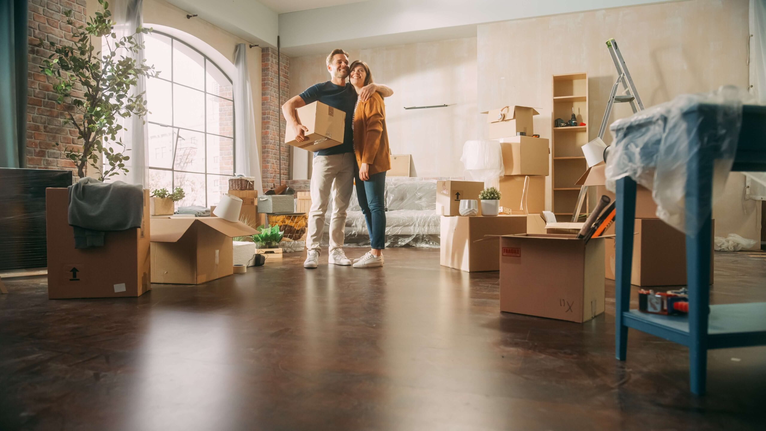 Couple moving into first home with boxes