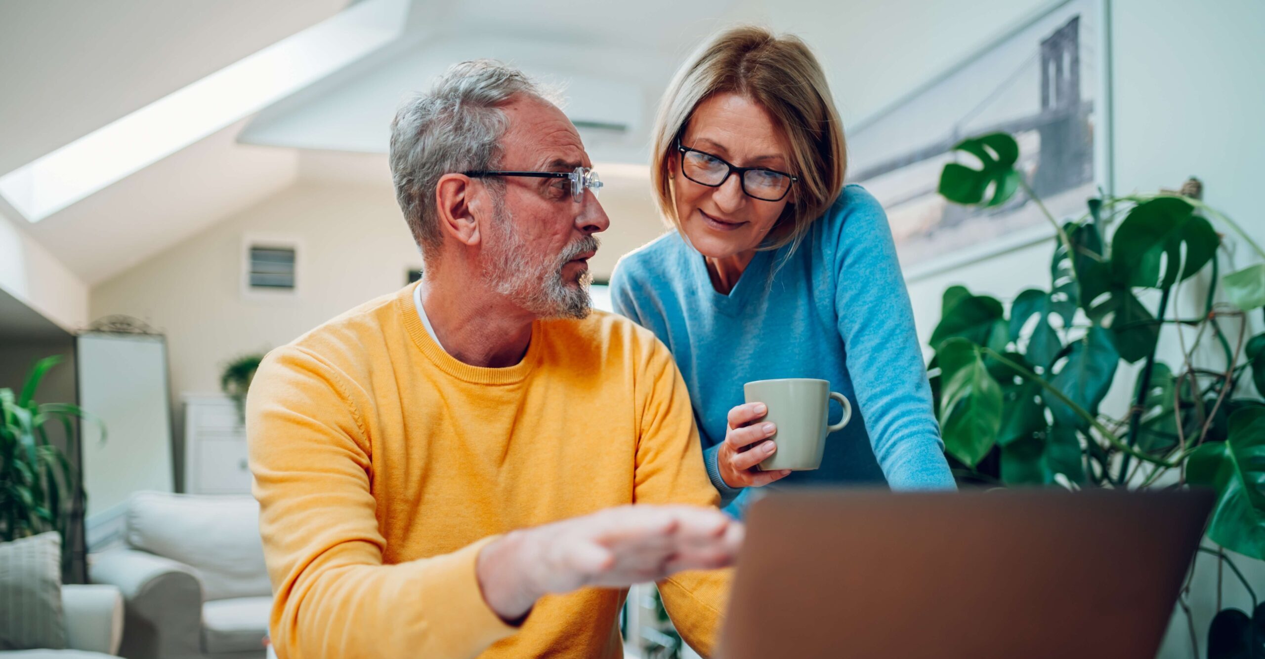 Mature couple looking at laptop together