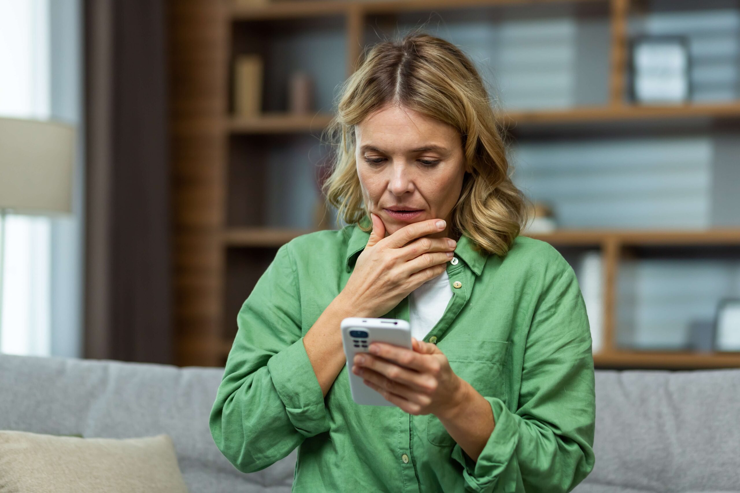 Concerned woman looking at phone