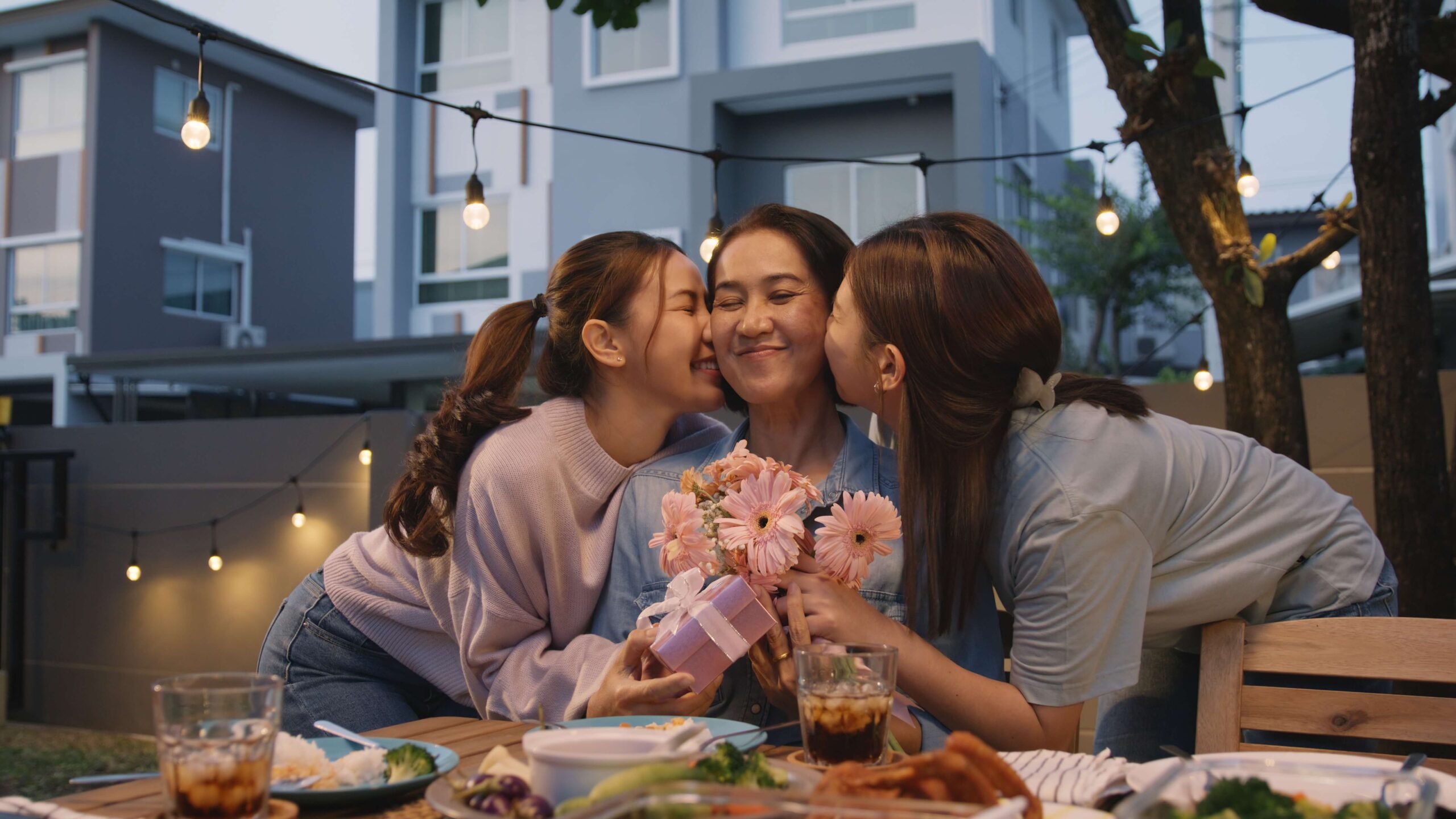 Asian mum with daughters happy outside with flowers