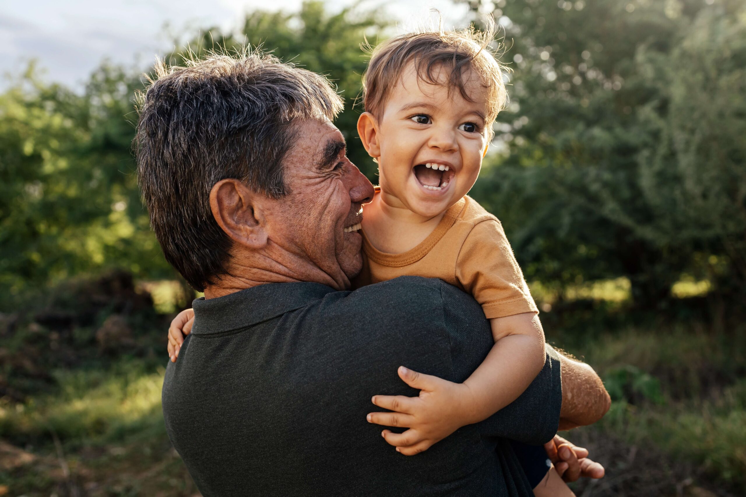 Happy grandad and grandson outside