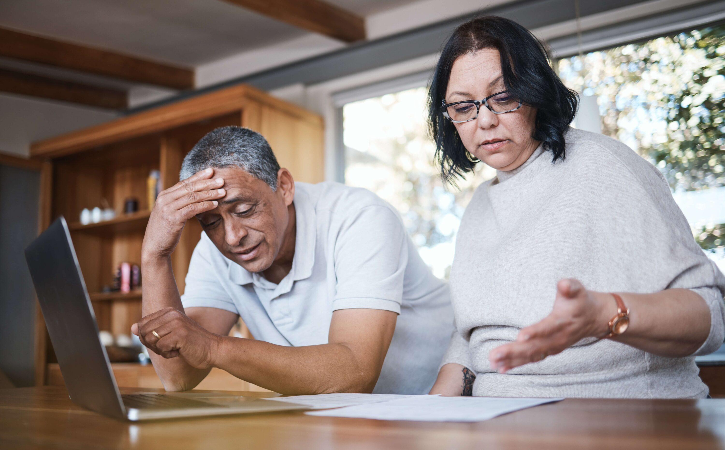 Couple stressed looking at bills