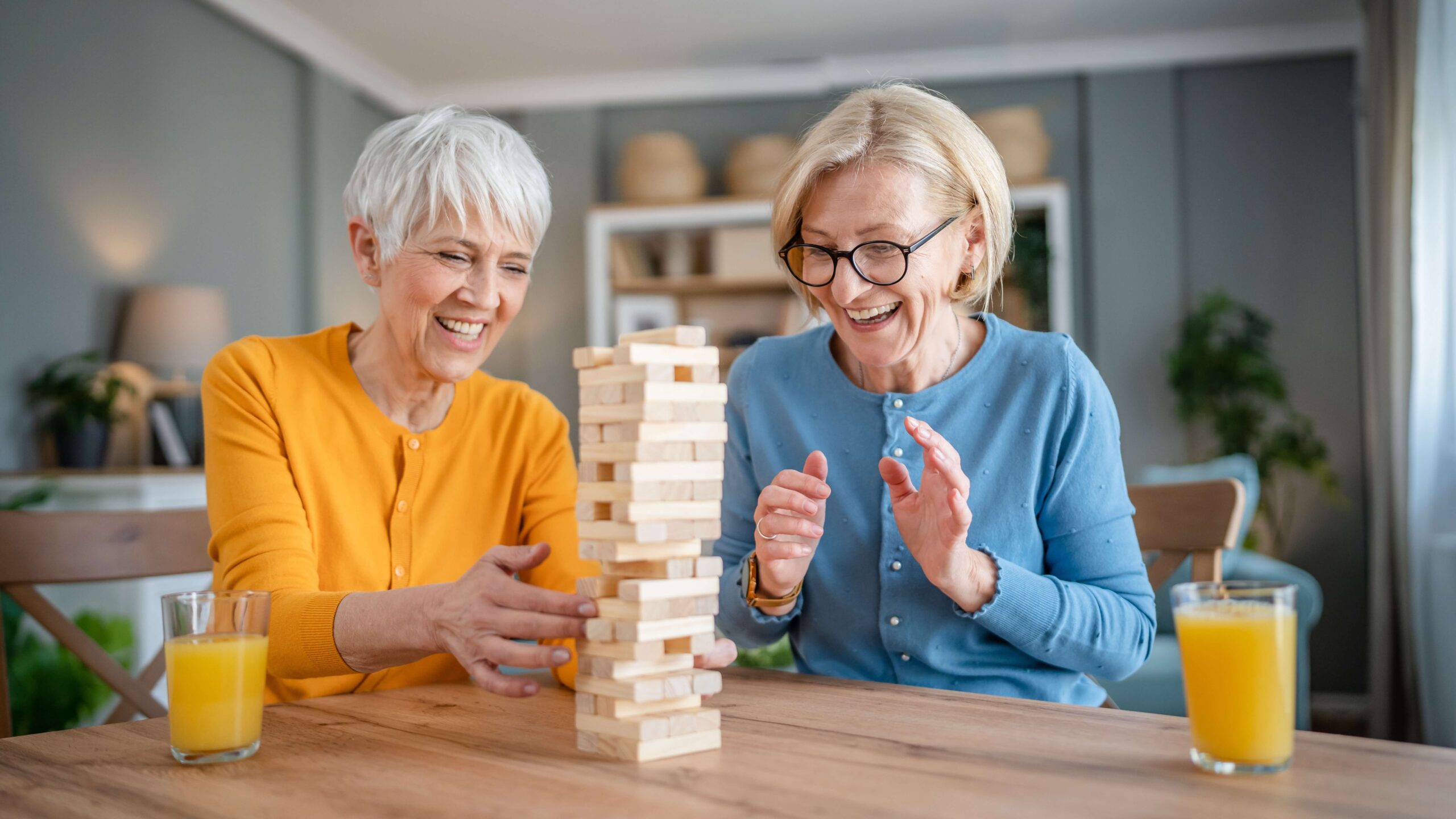 Mature female friends playing jenga