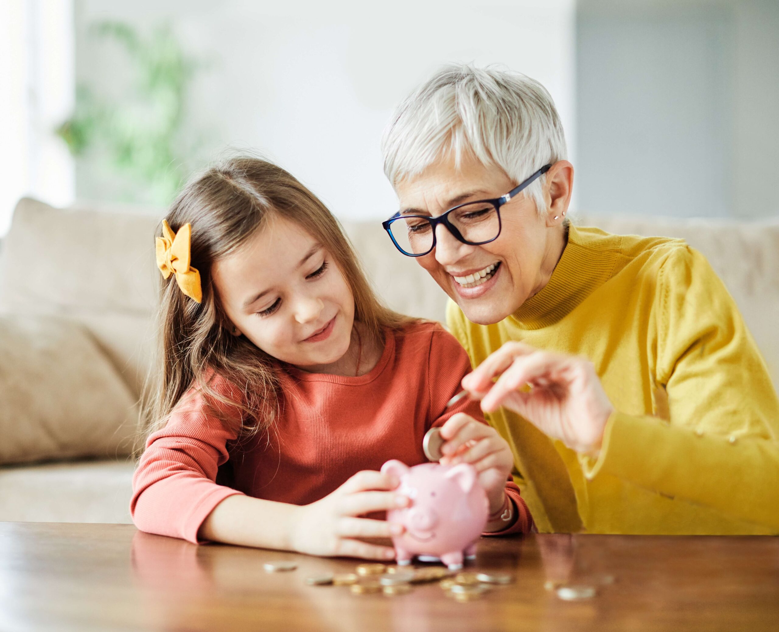 Grandmother and granddaughter piggy bank