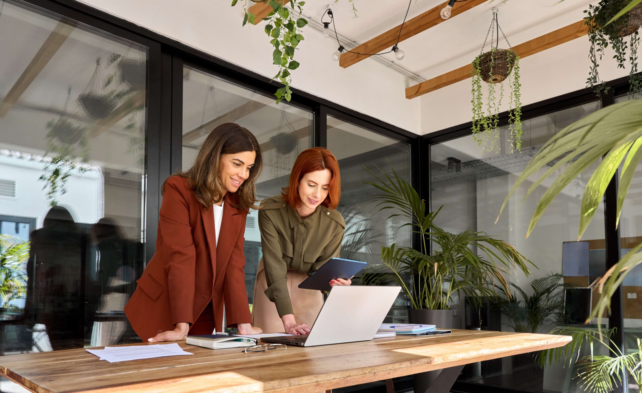 Young woman in office looking at laptop