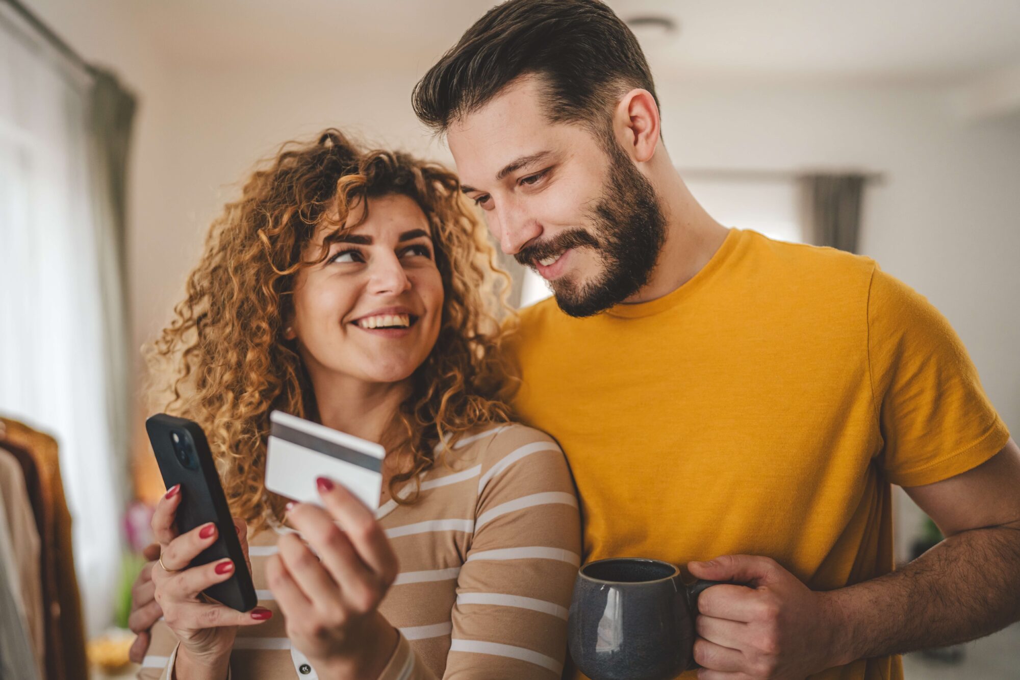 Couple happy looking at phone