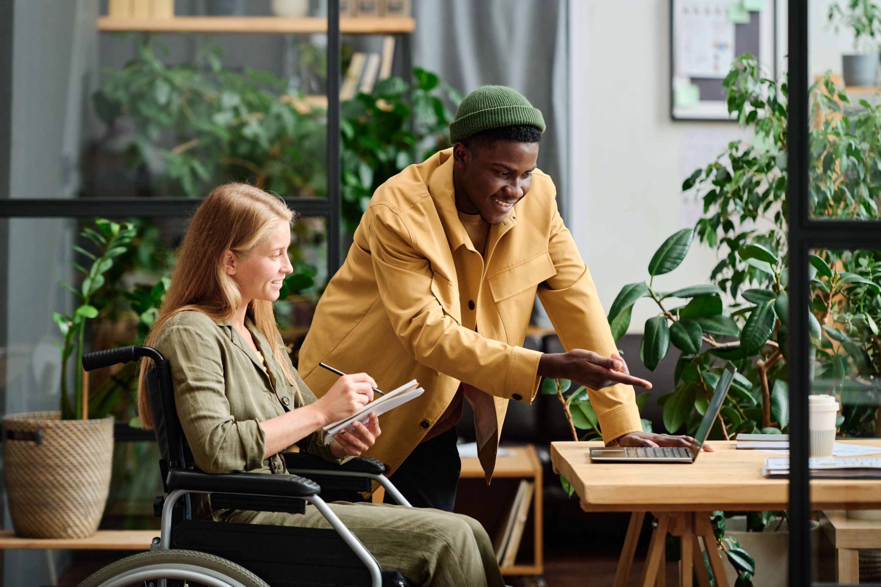 woman in wheelchair with man in office