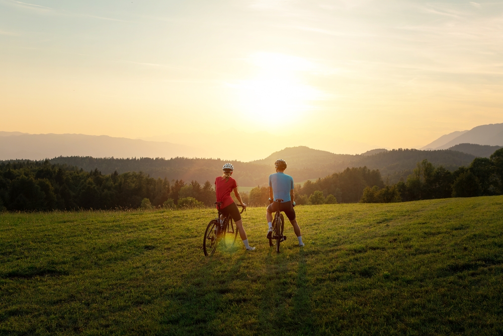 Two cyclists staring into the sunset